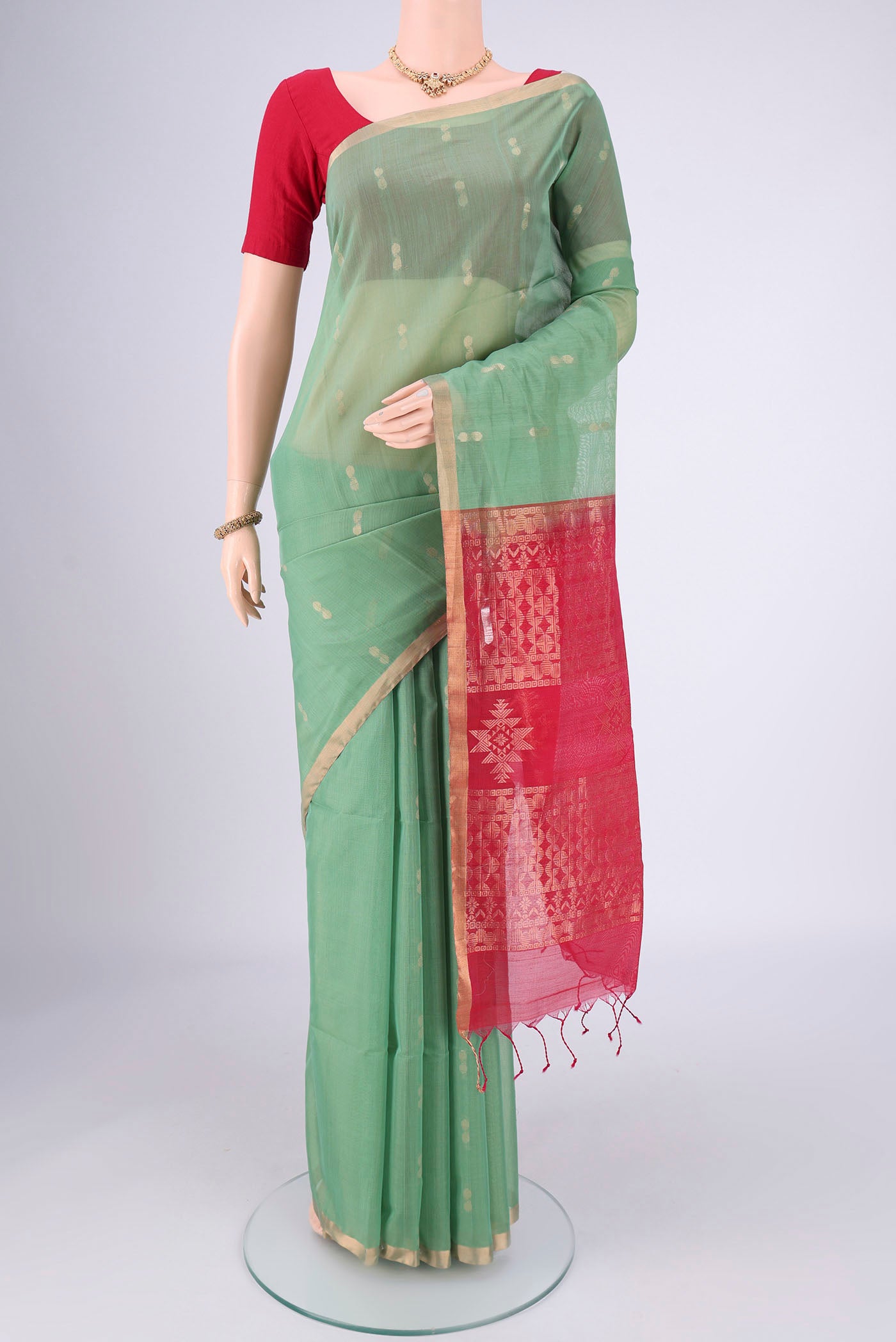 Sea Green Silk Cotton Saree with Zari Brocade on the body and Zari Border.  displayed on a mannequin