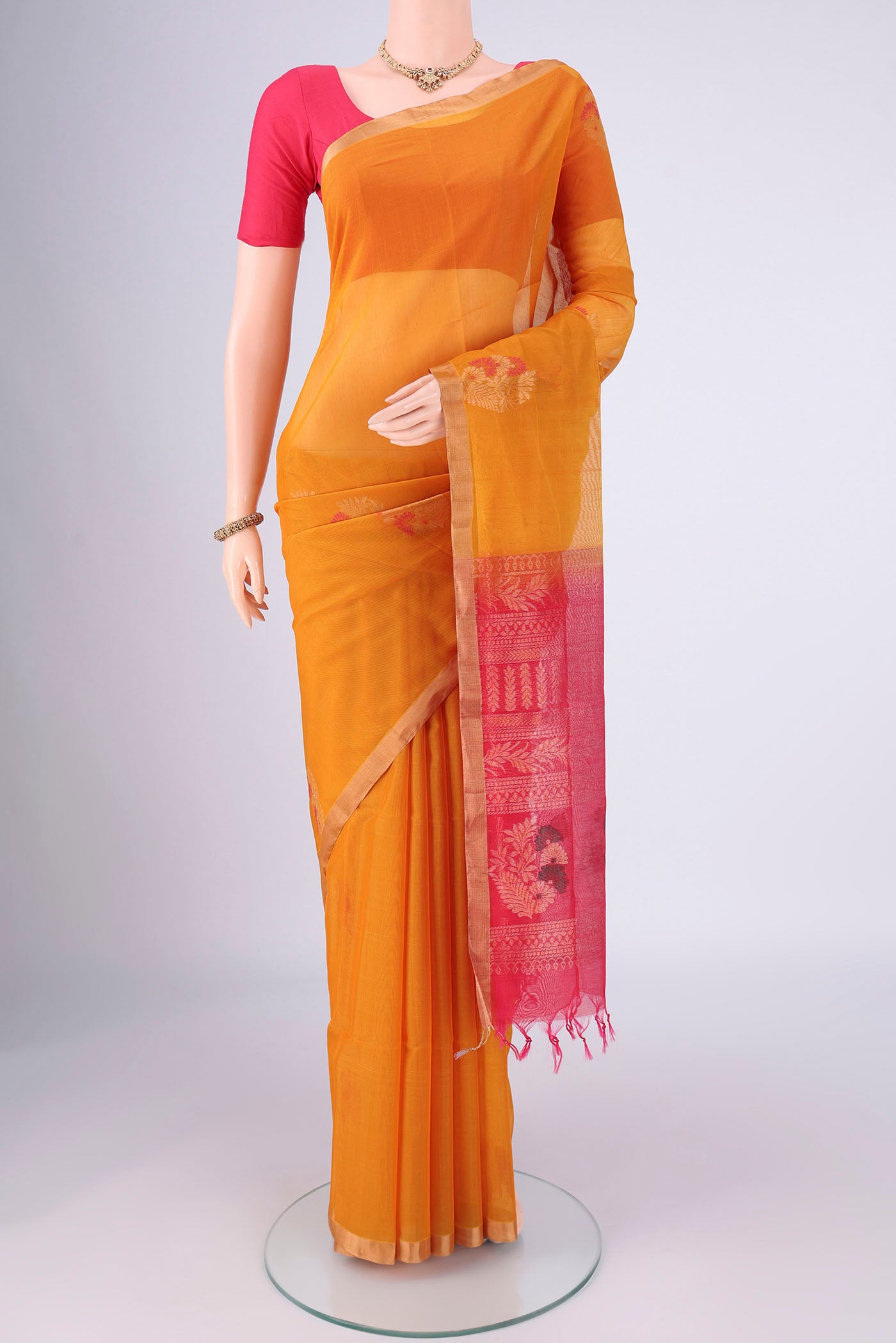 Mustard Silk Cotton Saree with Zari Brocade on the body and Zari Border.  displayed on a mannequin