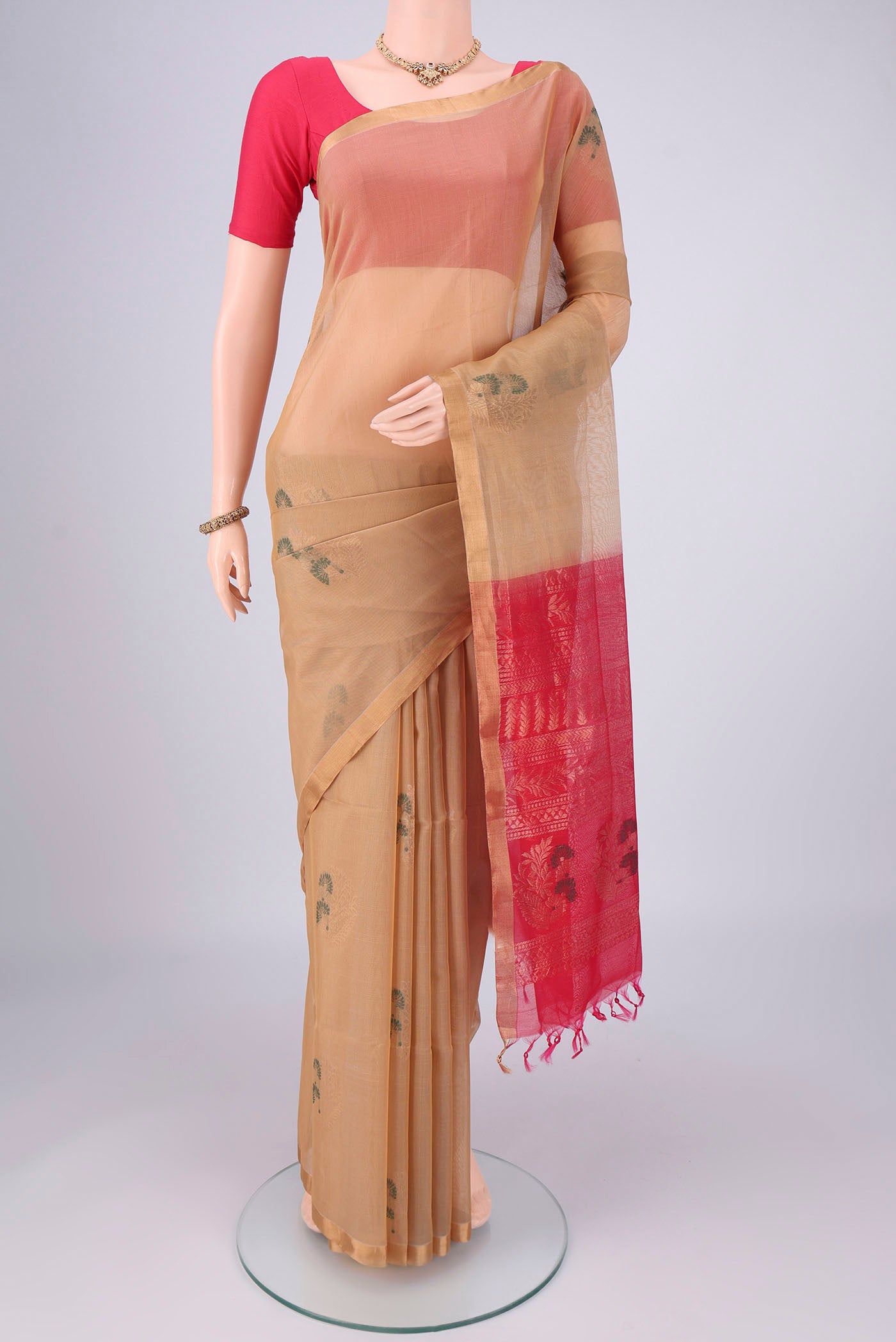 Beige Silk Cotton Saree with Zari Brocade on the body and Zari Border.  displayed on a mannequin