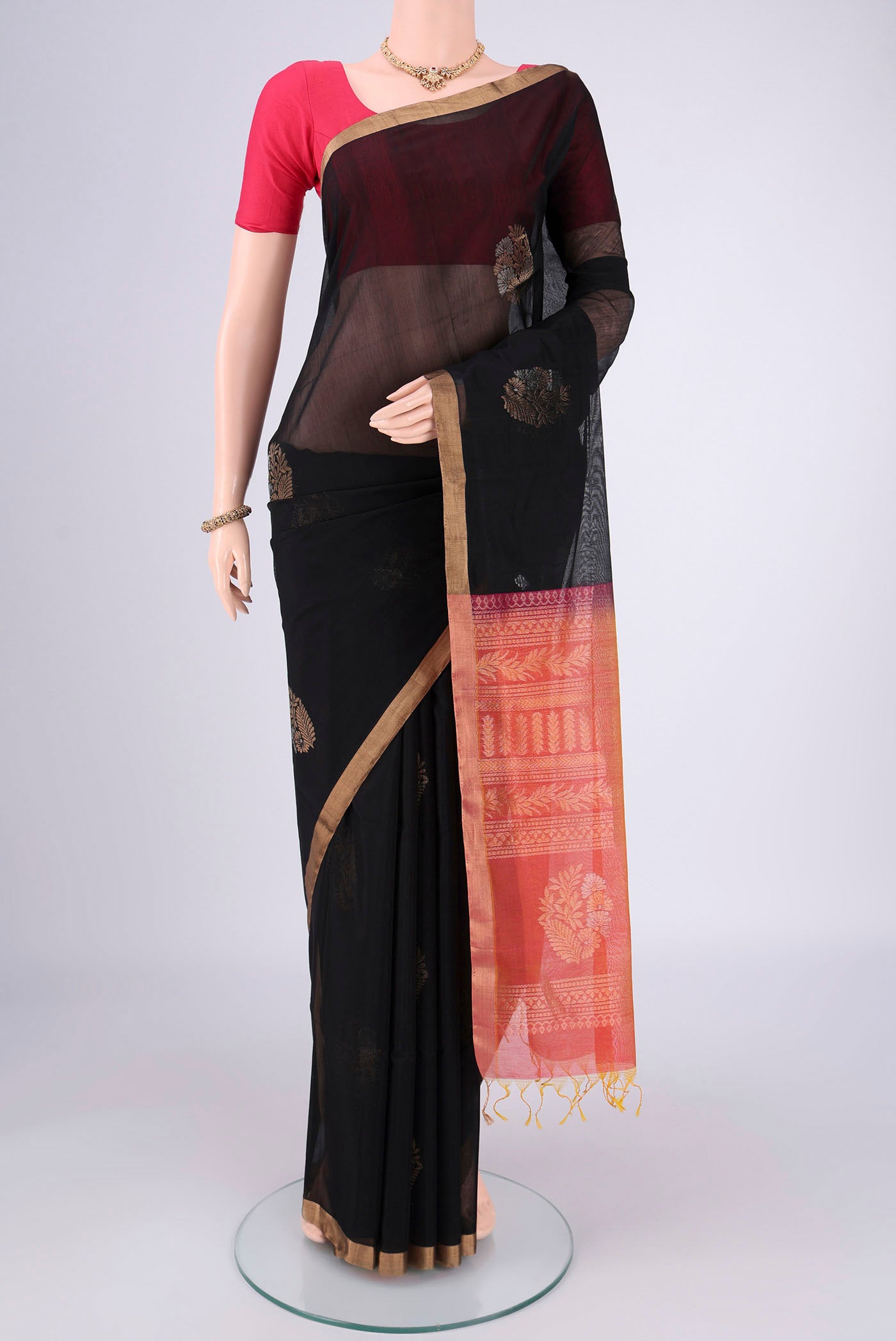Black Silk Cotton Saree with Zari Brocade on the body and Zari Border.  displayed on a mannequin
