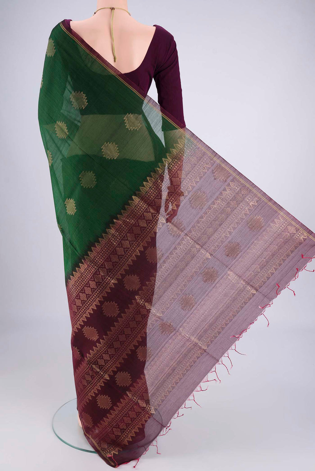 Flat view of Bottle Green Silk Cotton Saree with Zari Brocade on the body and Zari Border. 