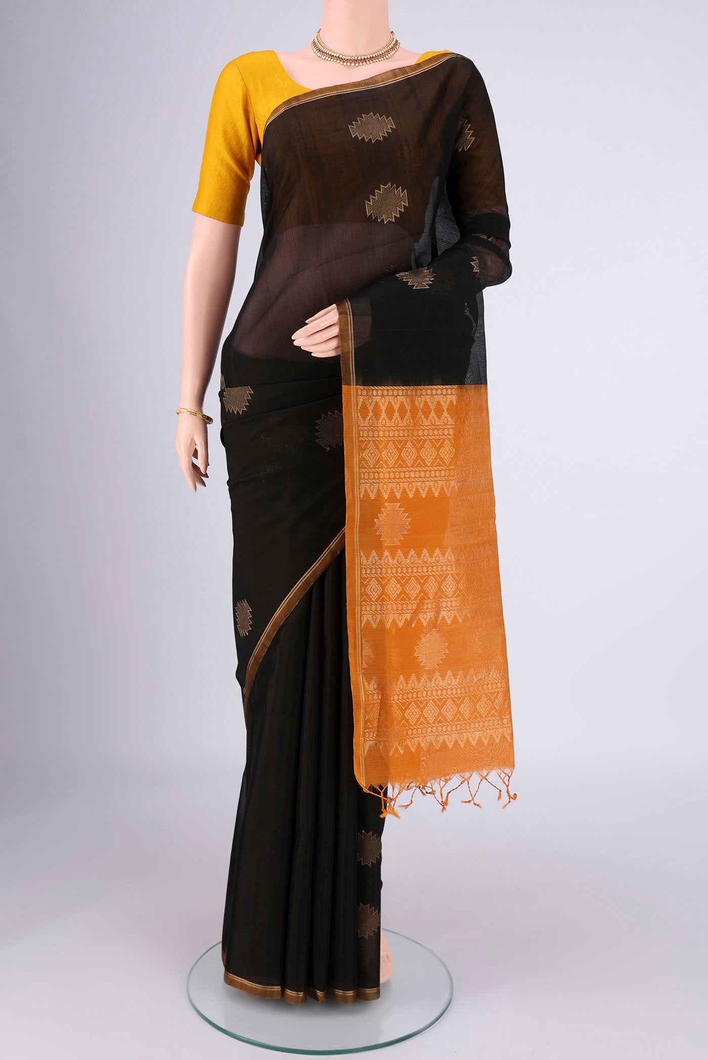 Black Silk Cotton Saree with Zari Butta on the body and Zari Border.  displayed on a mannequin