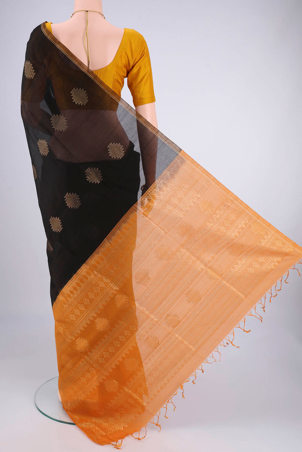 Flat view of Black Silk Cotton Saree with Zari Butta on the body and Zari Border. 