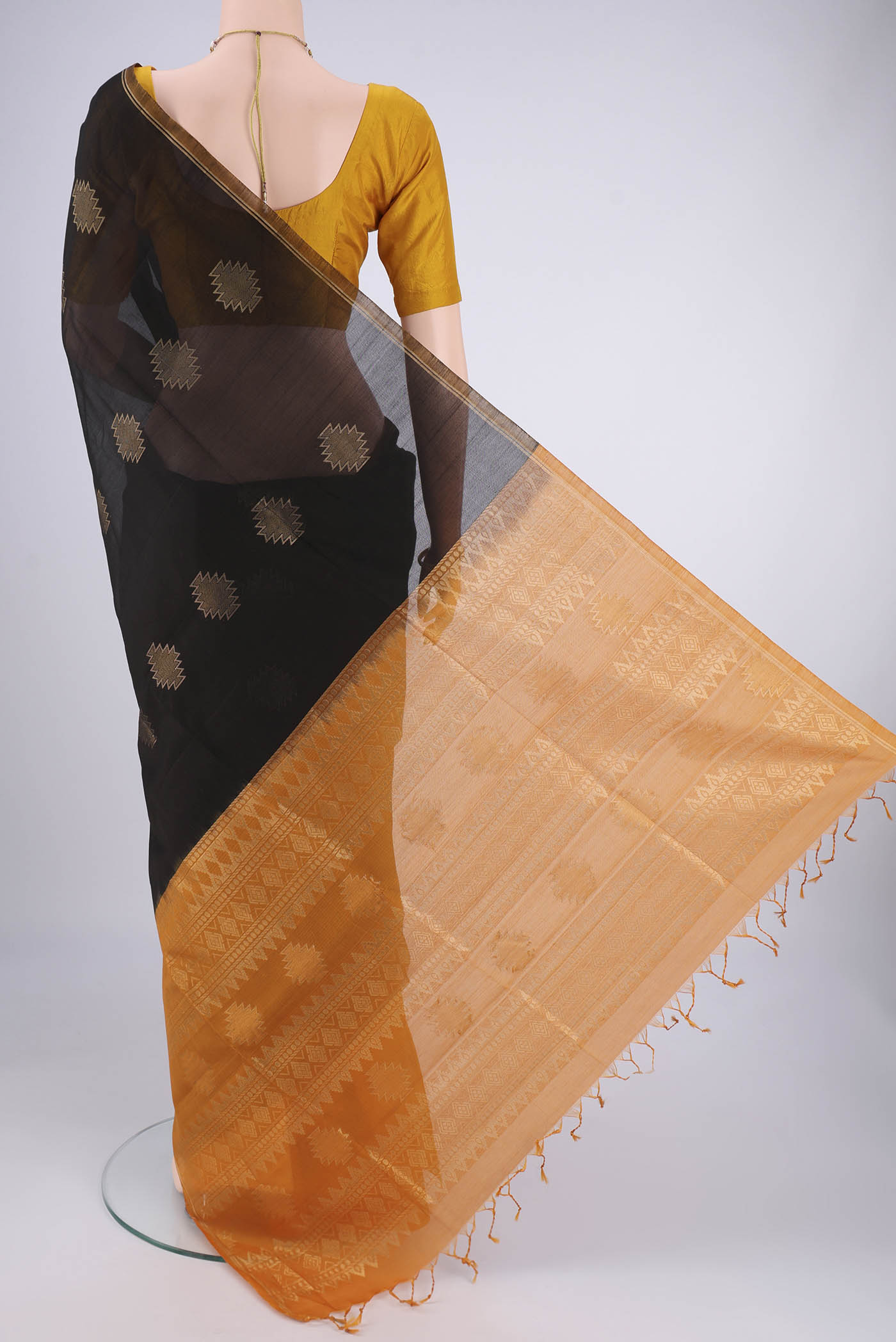 Flat view of Black Silk Cotton Saree with Zari Butta on the body and Zari Border. 