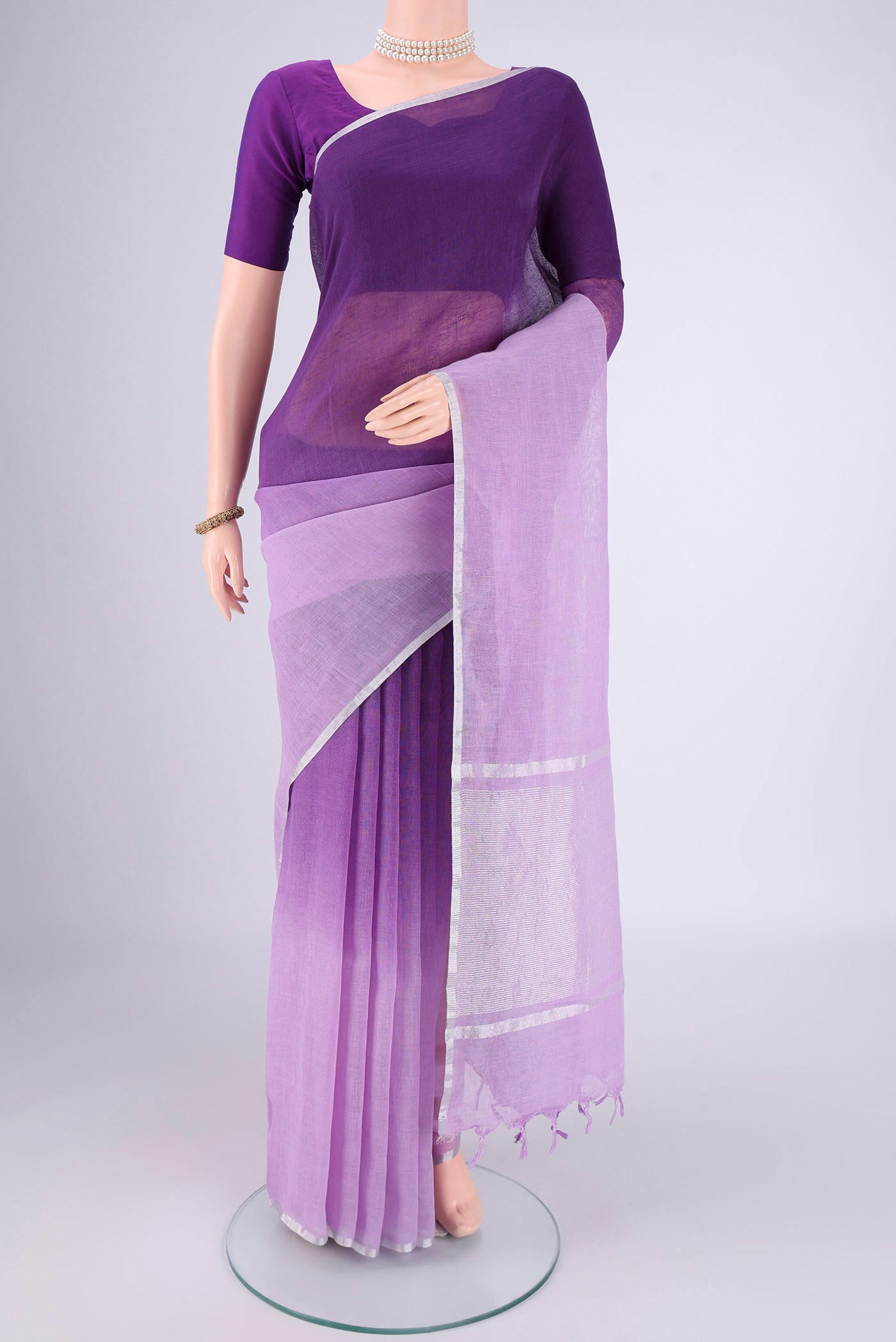Violet Linen Saree with Half And Half on the body and Thin Zari Line.  displayed on a mannequin