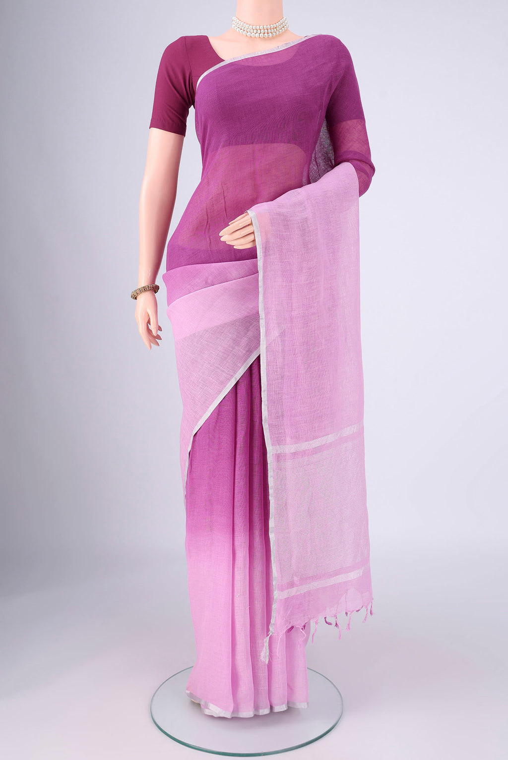 Mauve Linen Saree with Half And Half on the body and Thin Zari Line.  displayed on a mannequin