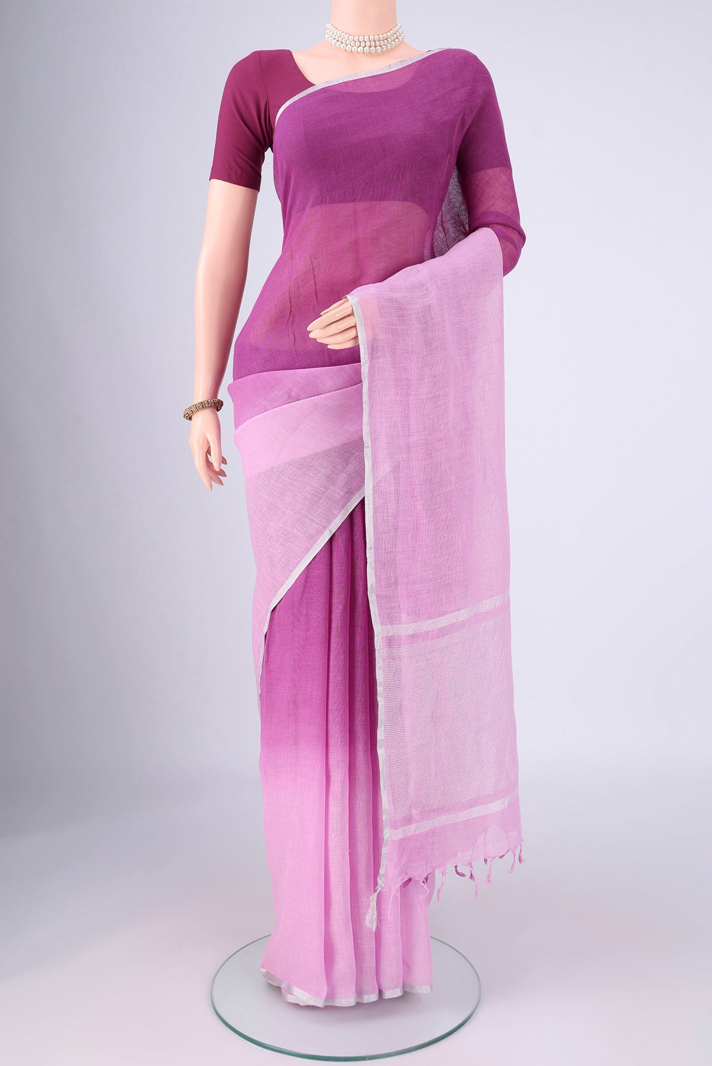 Mauve Linen Saree with Half And Half on the body and Thin Zari Line.  displayed on a mannequin