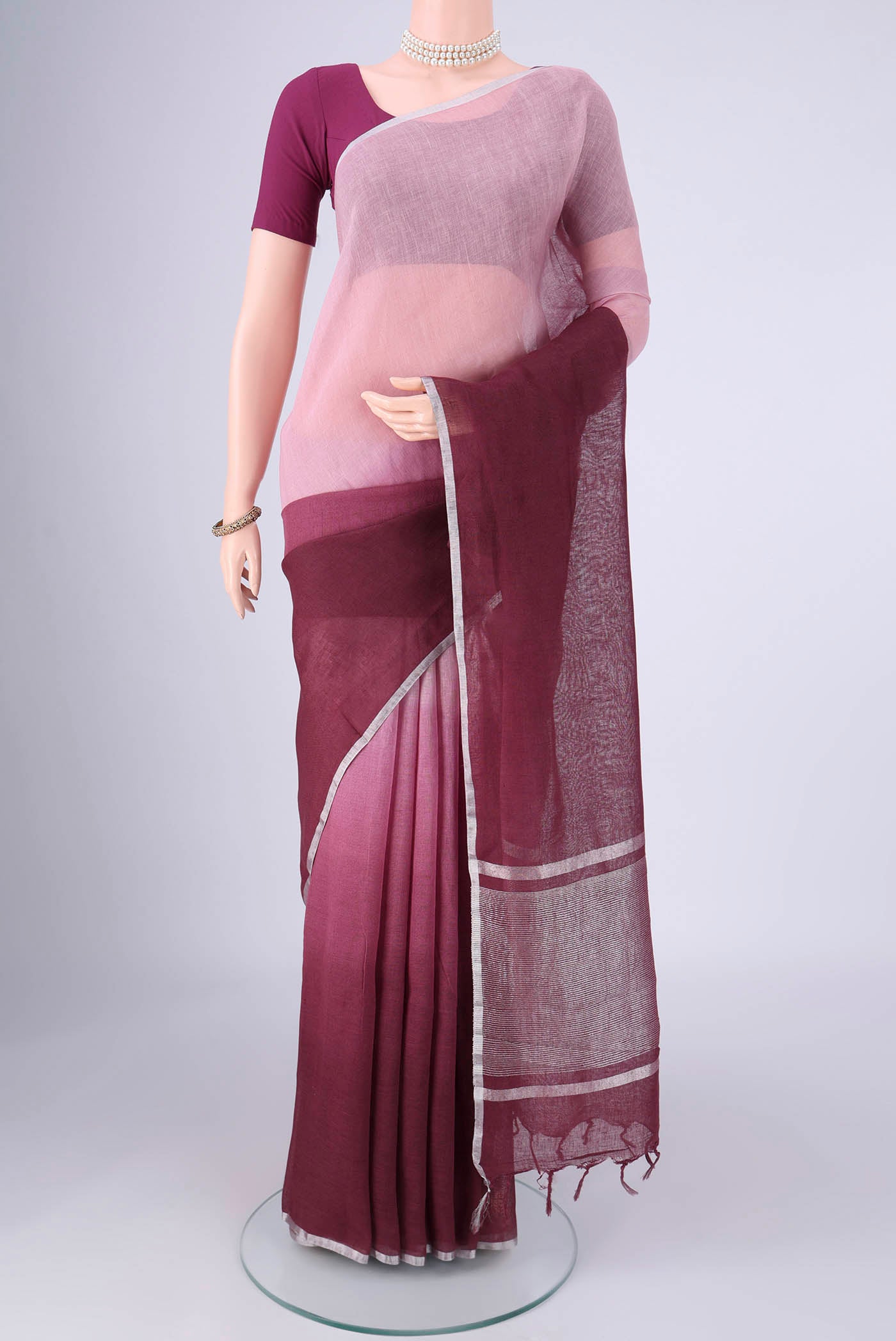 Mauve Linen Saree with Plain Body and Zari Border.  displayed on a mannequin