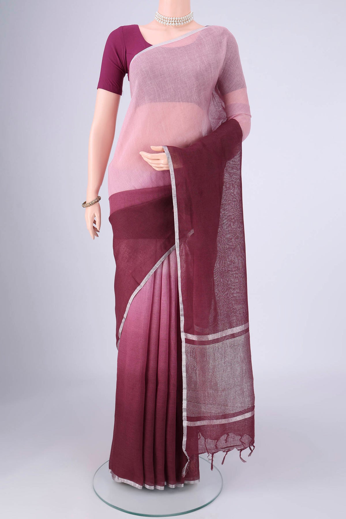 Mauve Linen Saree with Plain Body and Zari Border.  displayed on a mannequin