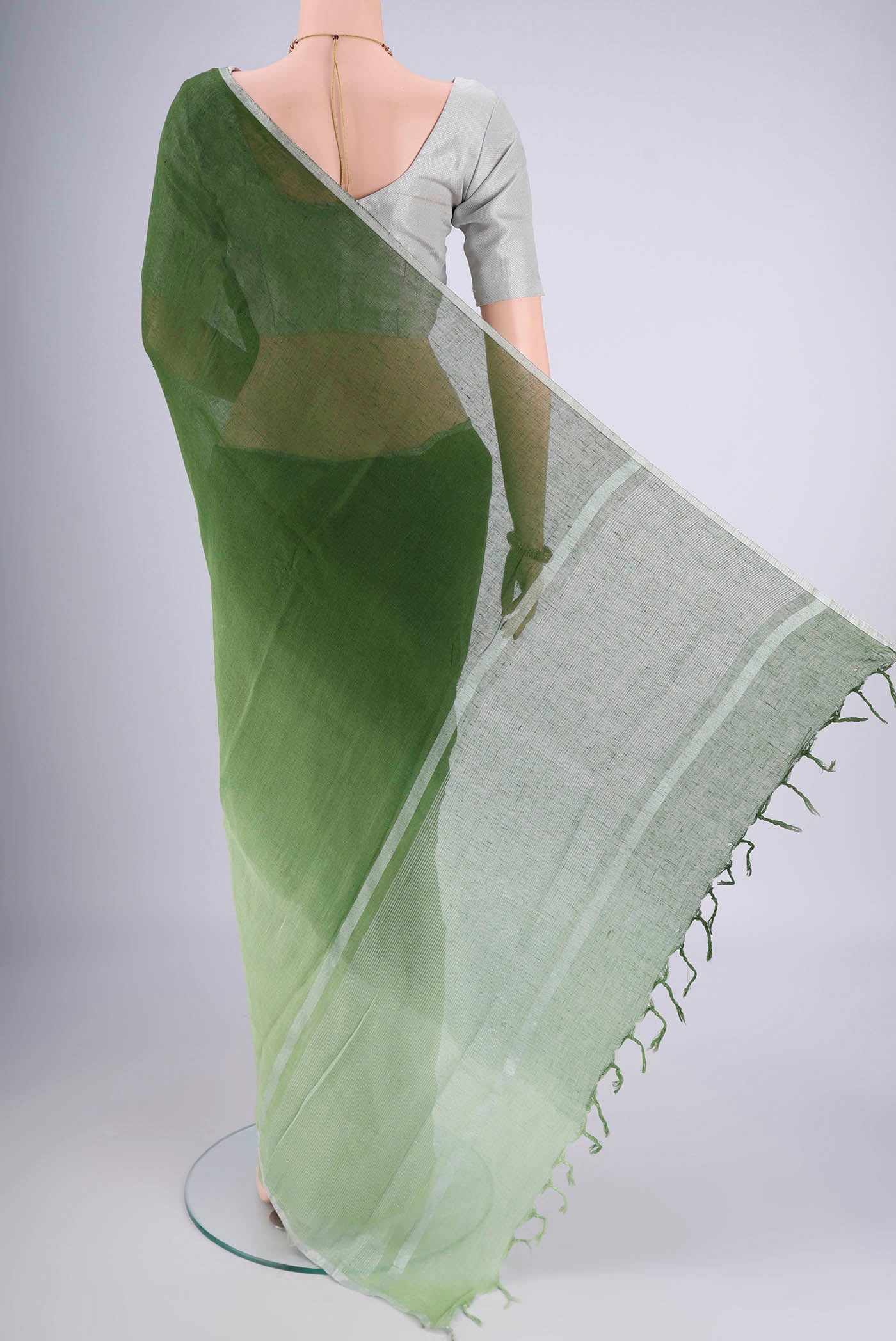 Flat view of Light Green Linen Saree with Half And Half on the body and Thin Zari Line. 