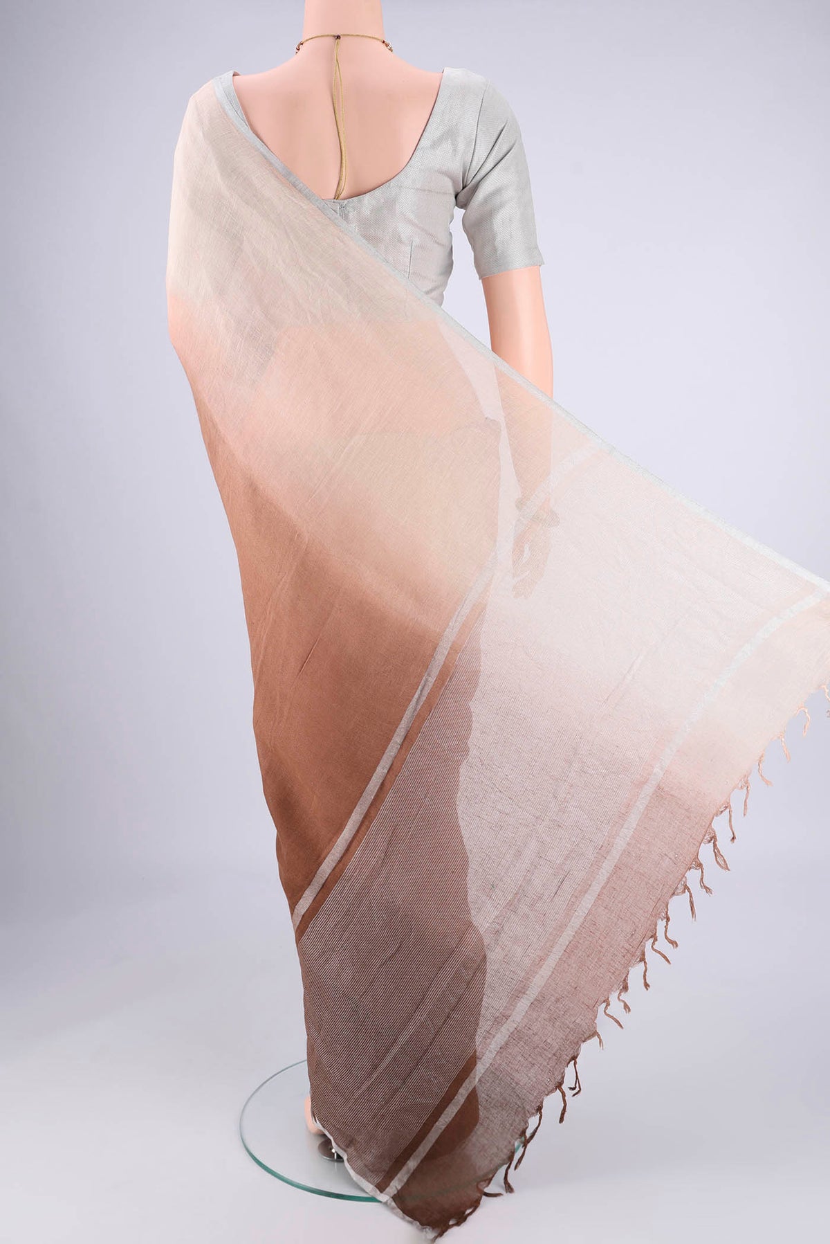 Flat view of Brown Linen Saree with Half And Half on the body and Thin Zari Line. 