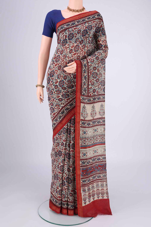 Beige Chanderi Silk Cotton Saree with Ajrakh Print on the body and Zari Border.  displayed on a mannequin