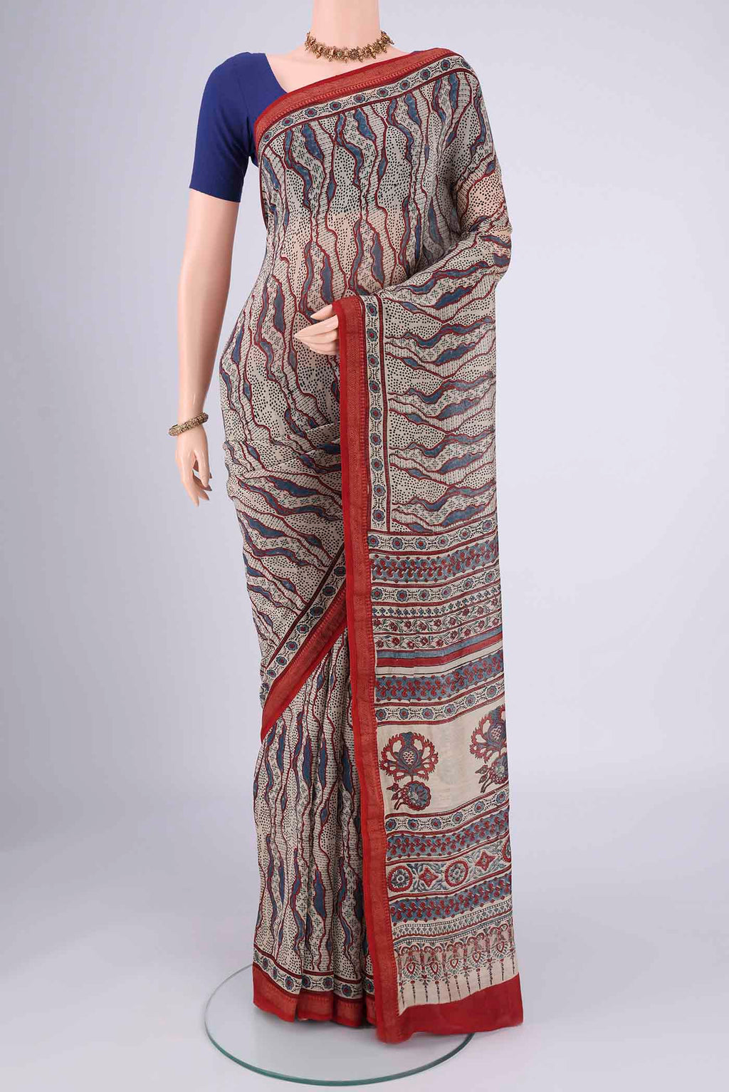 Beige Chanderi Silk Cotton Saree with Ajrakh Print on the body and Zari Border.  displayed on a mannequin