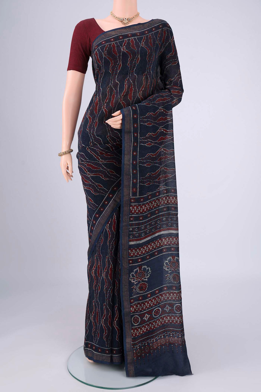 Navy Blue Chanderi Silk Cotton Saree with Ajrakh Print on the body and Zari Border.  displayed on a mannequin