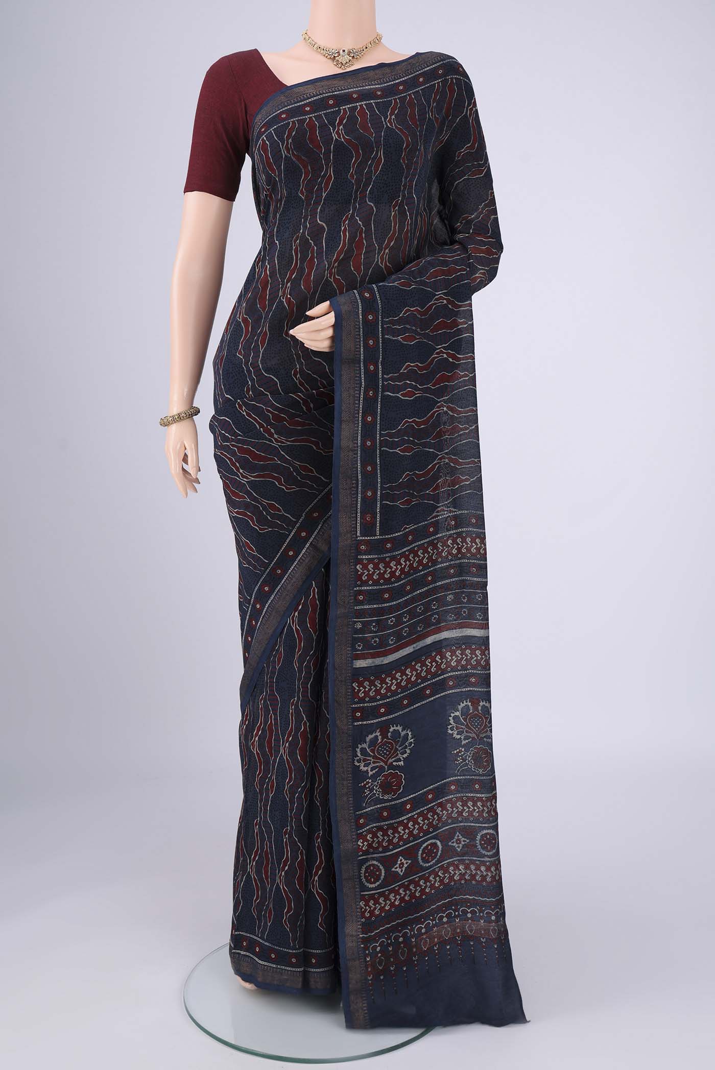 Navy Blue Chanderi Silk Cotton Saree with Ajrakh Print on the body and Zari Border.  displayed on a mannequin
