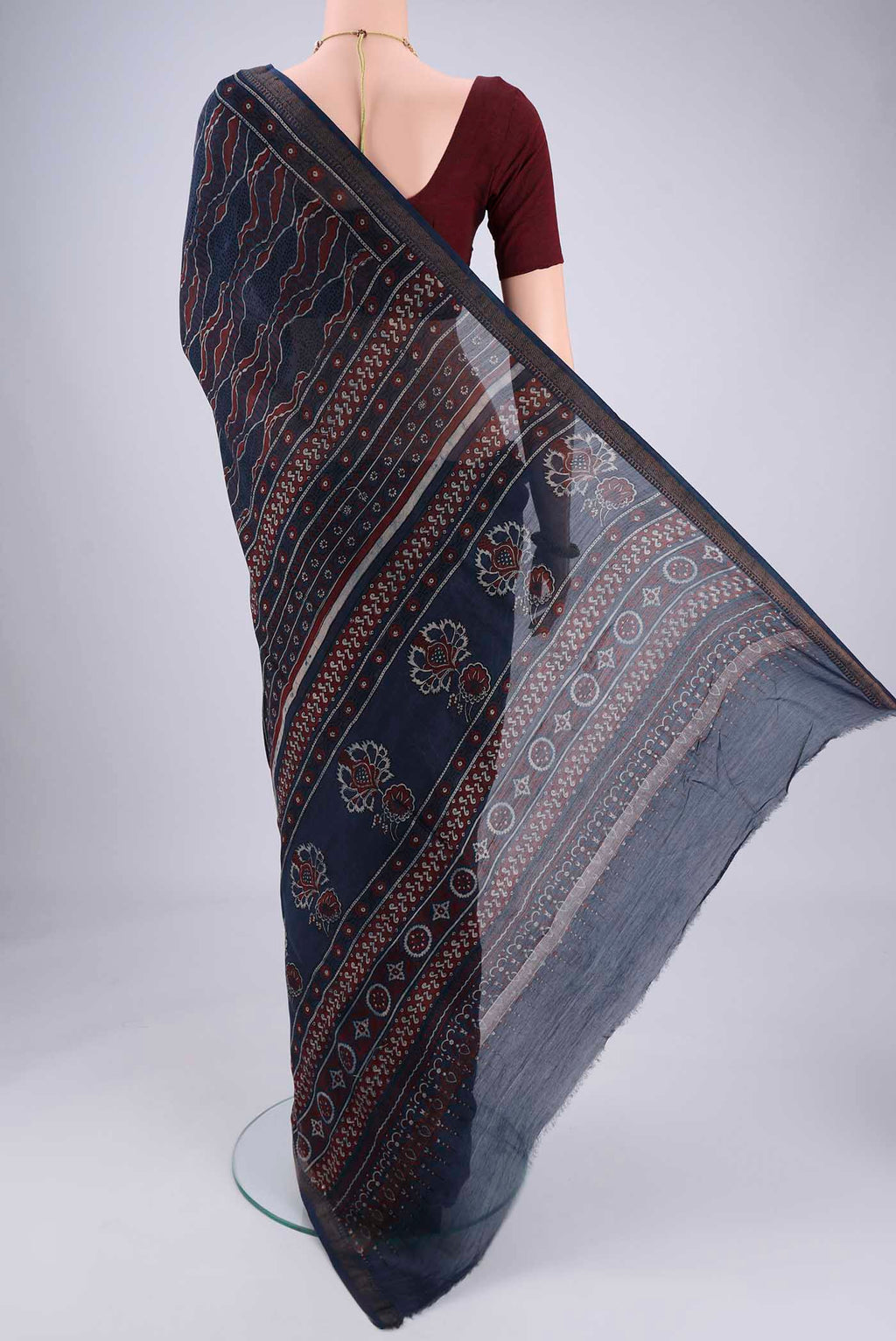 Flat view of Navy Blue Chanderi Silk Cotton Saree with Ajrakh Print on the body and Zari Border. 