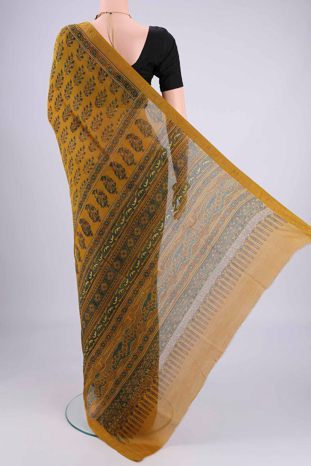 Flat view of Mustard Chanderi Silk Cotton Saree with Ajrakh Print on the body and Zari Border. 
