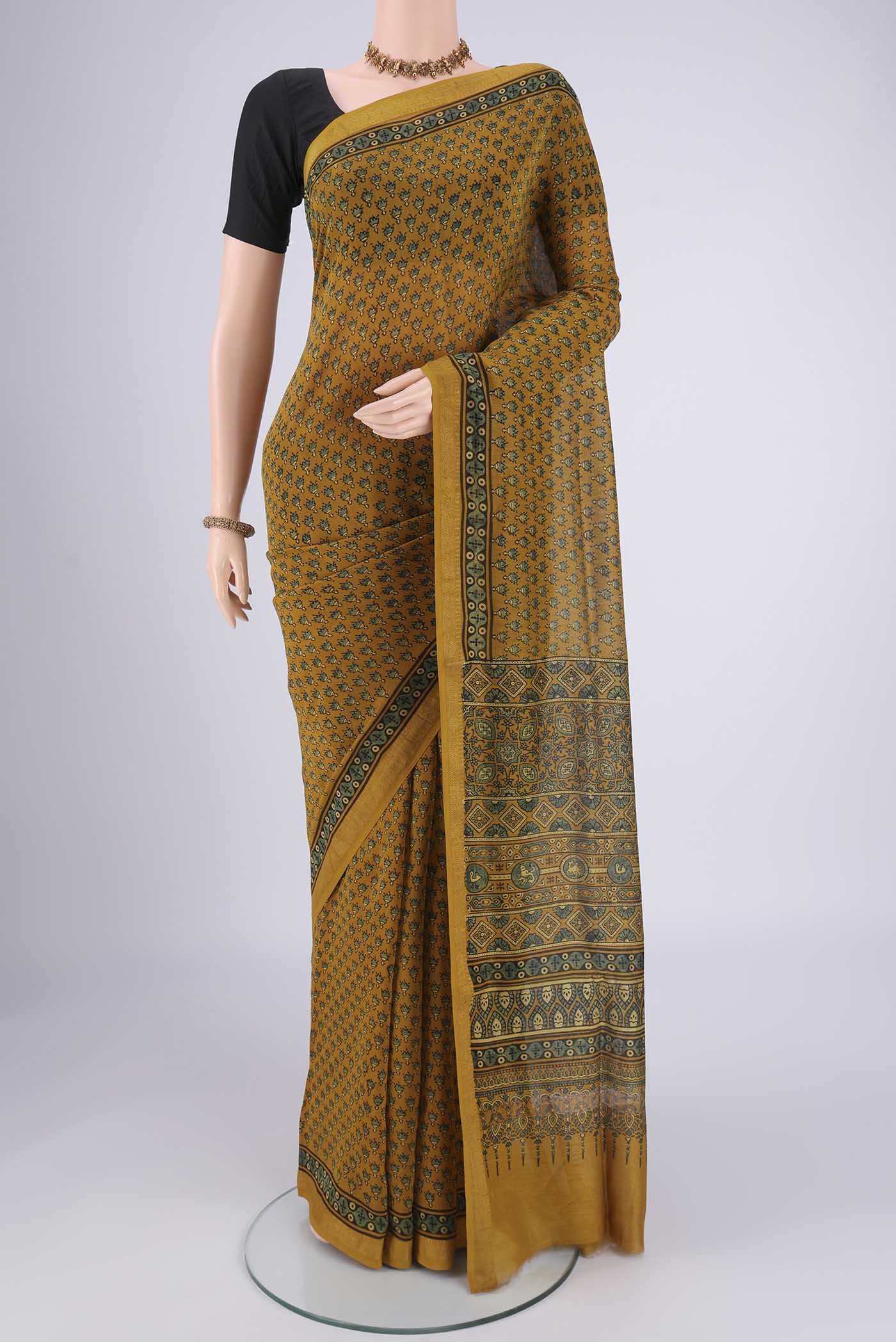 Mustard Chanderi Silk Cotton Saree with Ajrakh Print on the body and Zari Border.  displayed on a mannequin