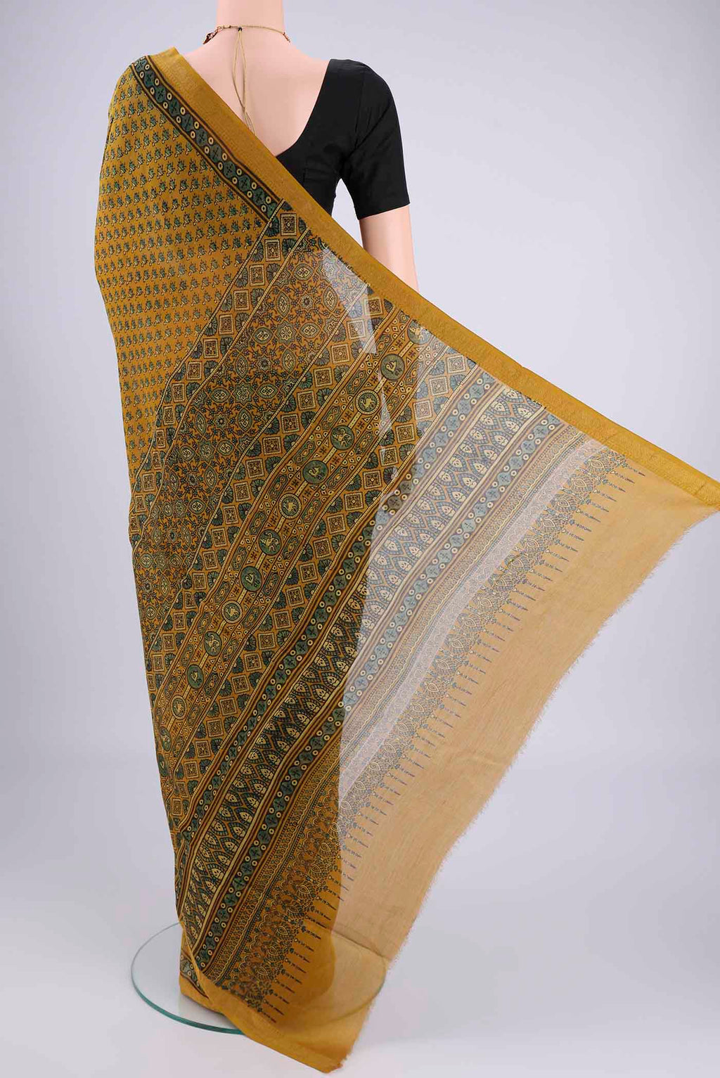 Flat view of Mustard Chanderi Silk Cotton Saree with Ajrakh Print on the body and Zari Border. 