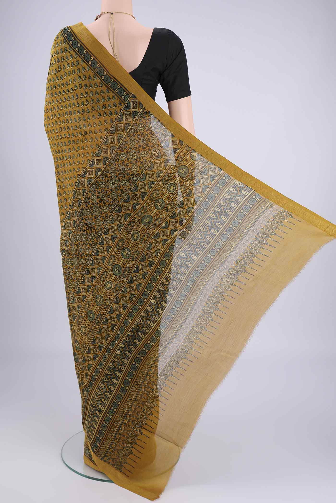 Flat view of Mustard Chanderi Silk Cotton Saree with Ajrakh Print on the body and Zari Border. 