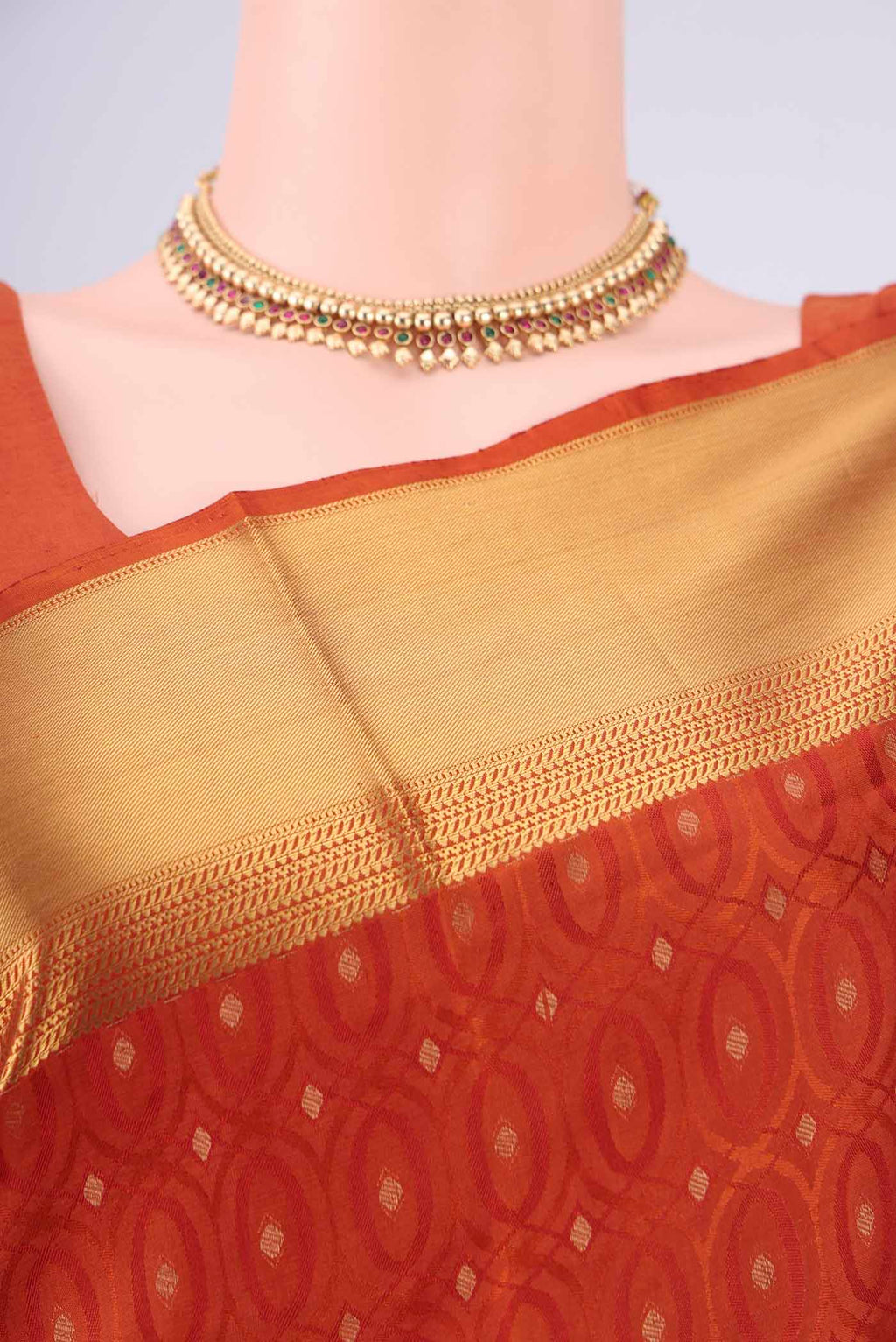 Border image of Rust Soft Silk Saree with Jacquard With Thread Butta on the body and Zari Border. 