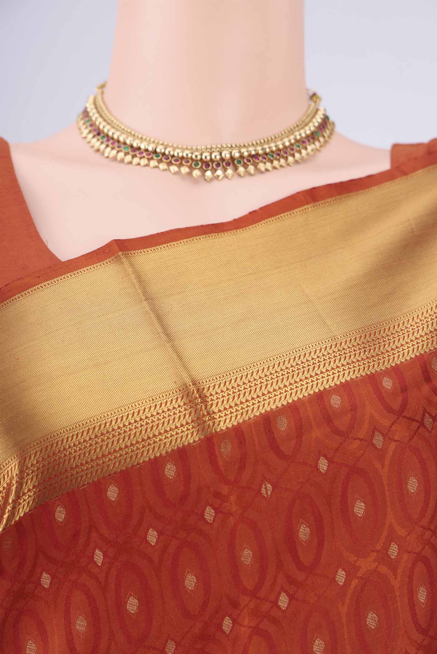 Border image of Rust Soft Silk Saree with Jacquard With Thread Butta on the body and Zari Border. 