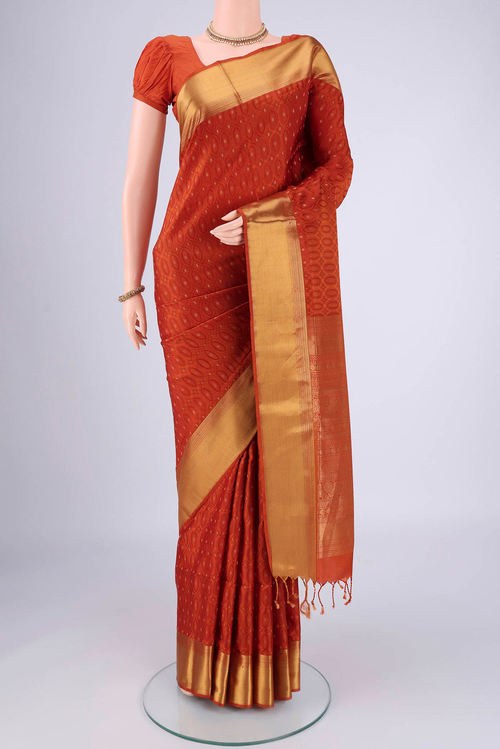 Rust Soft Silk Saree with Jacquard With Thread Butta on the body and Zari Border.  displayed on a mannequin