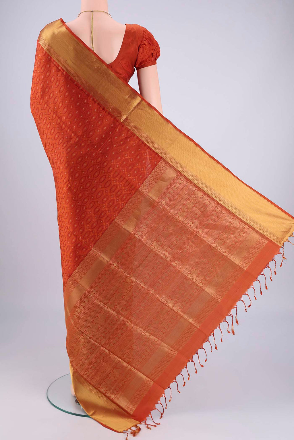 Flat view of Rust Soft Silk Saree with Jacquard With Thread Butta on the body and Zari Border. 