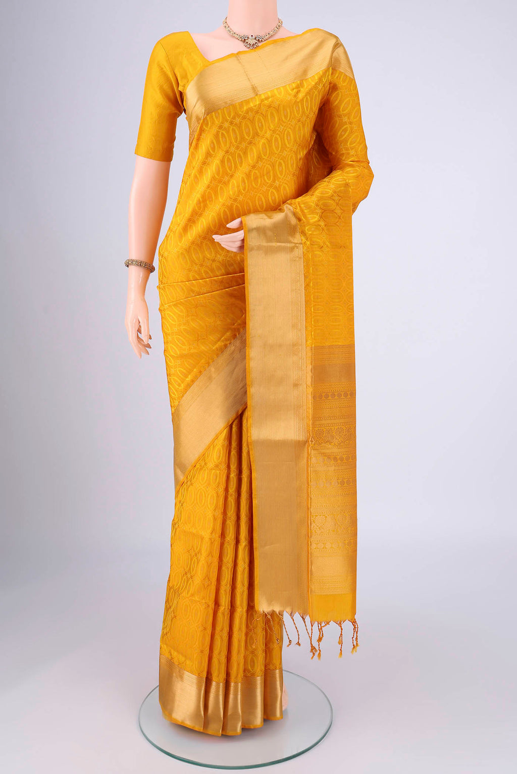 Yellow Soft Silk Saree with Jacquard With Thread Butta on the body and Zari Border.  displayed on a mannequin