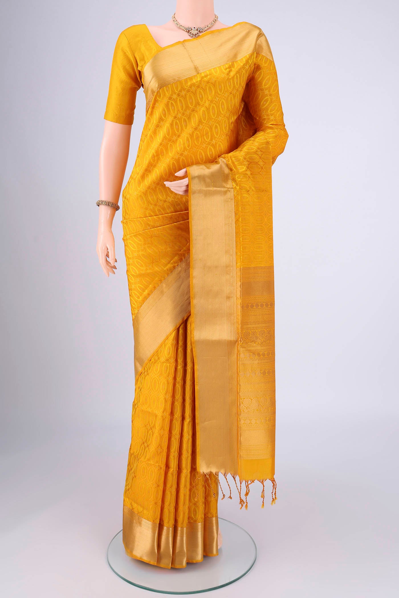 Yellow Soft Silk Saree with Jacquard With Thread Butta on the body and Zari Border.  displayed on a mannequin
