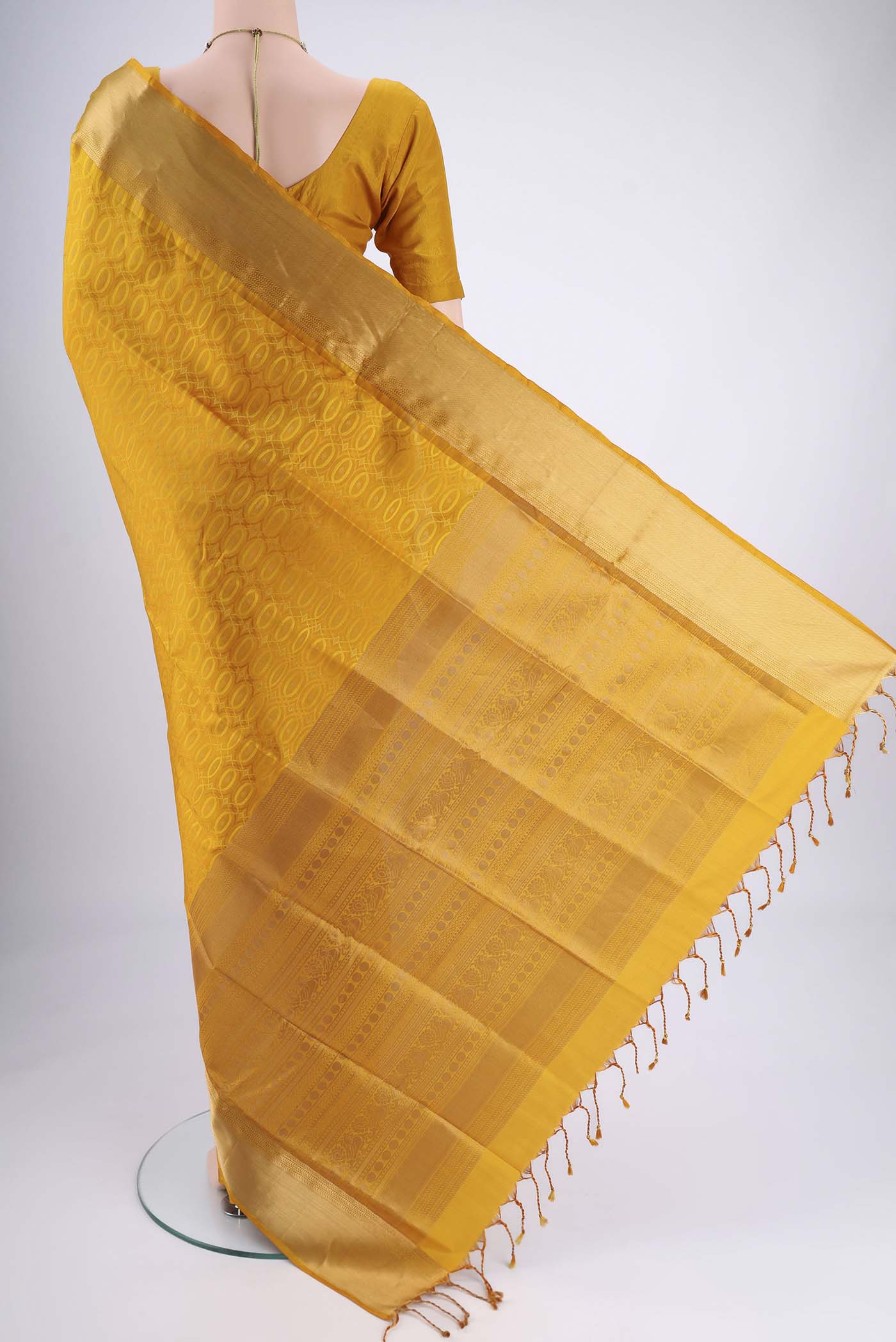 Flat view of Yellow Soft Silk Saree with Jacquard With Thread Butta on the body and Zari Border. 
