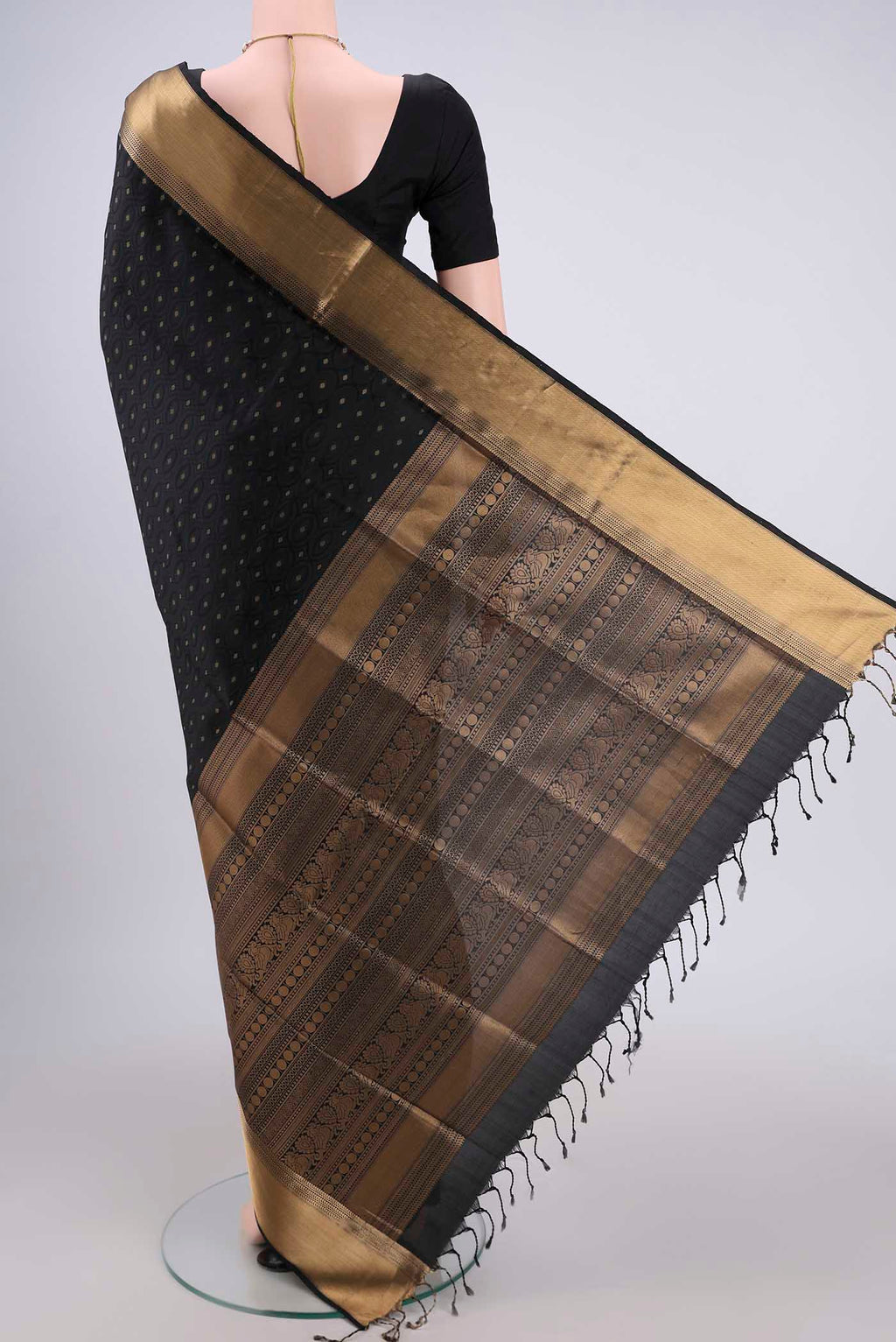 Flat view of Black Baluchari Silk Saree with Jacquard With Zari Butta on the body and Zari Border. 