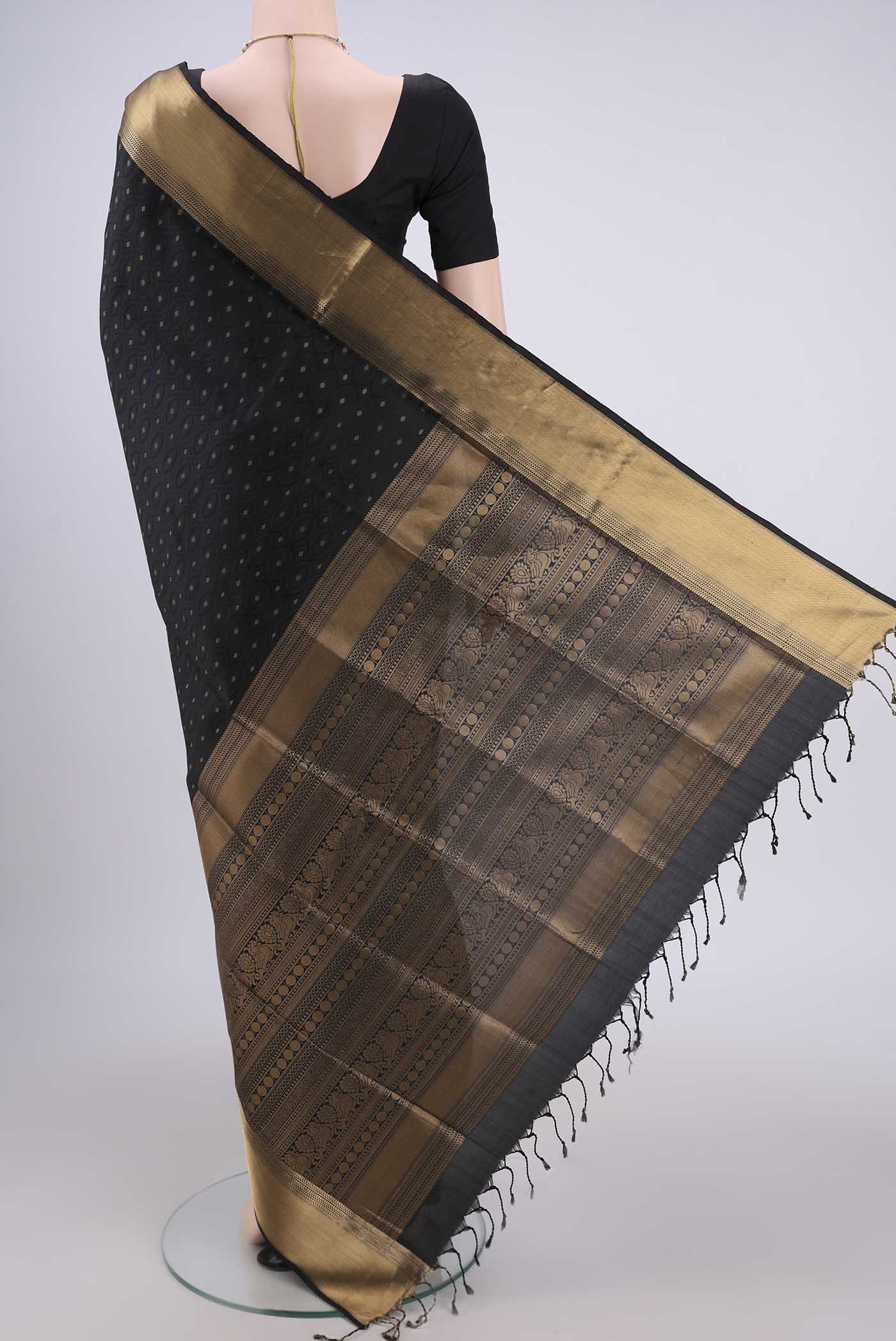 Flat view of Black Baluchari Silk Saree with Jacquard With Zari Butta on the body and Zari Border. 