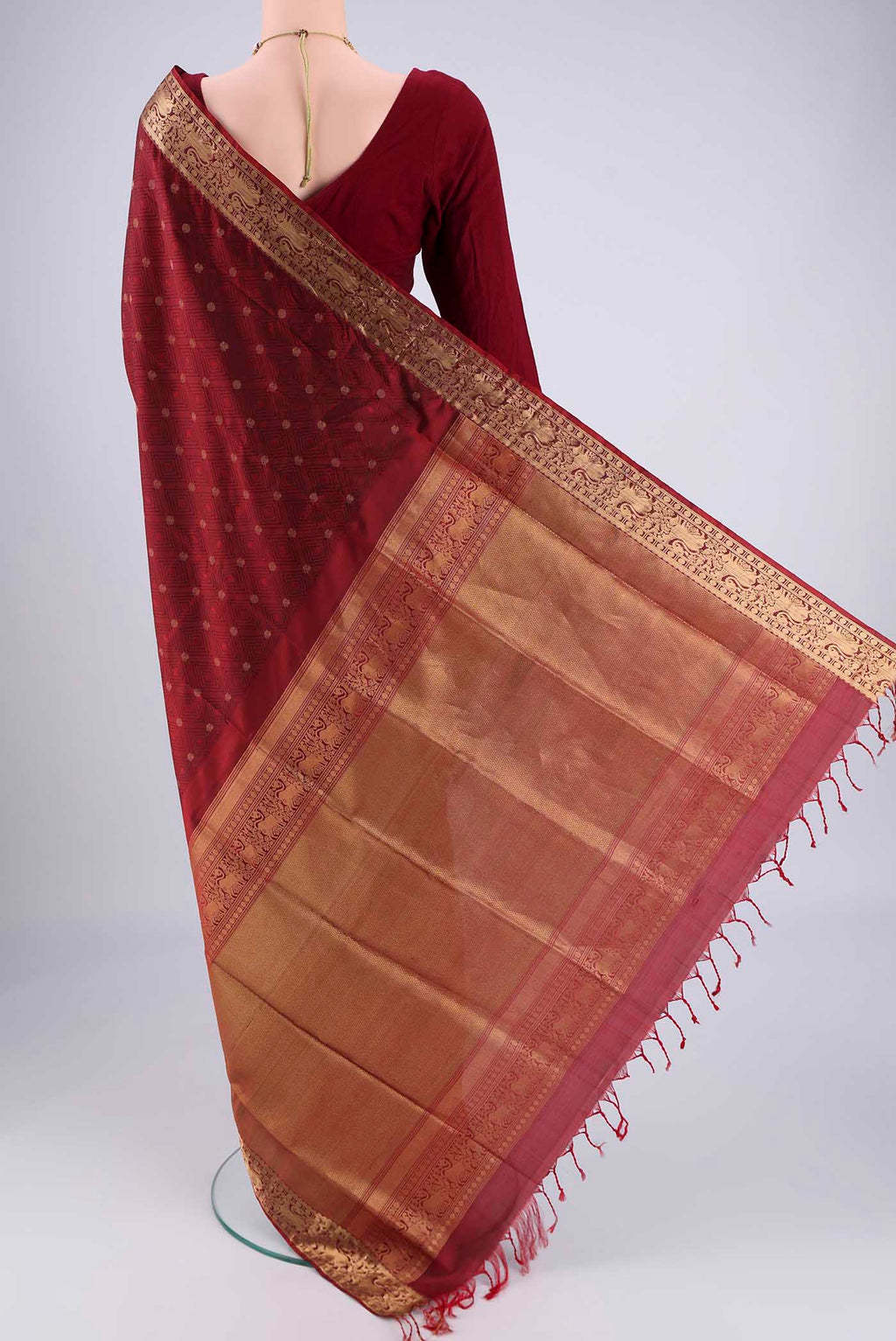 Flat view of Maroon Soft Silk Saree with Jacquard With Thread Butta on the body and Zari Border. 