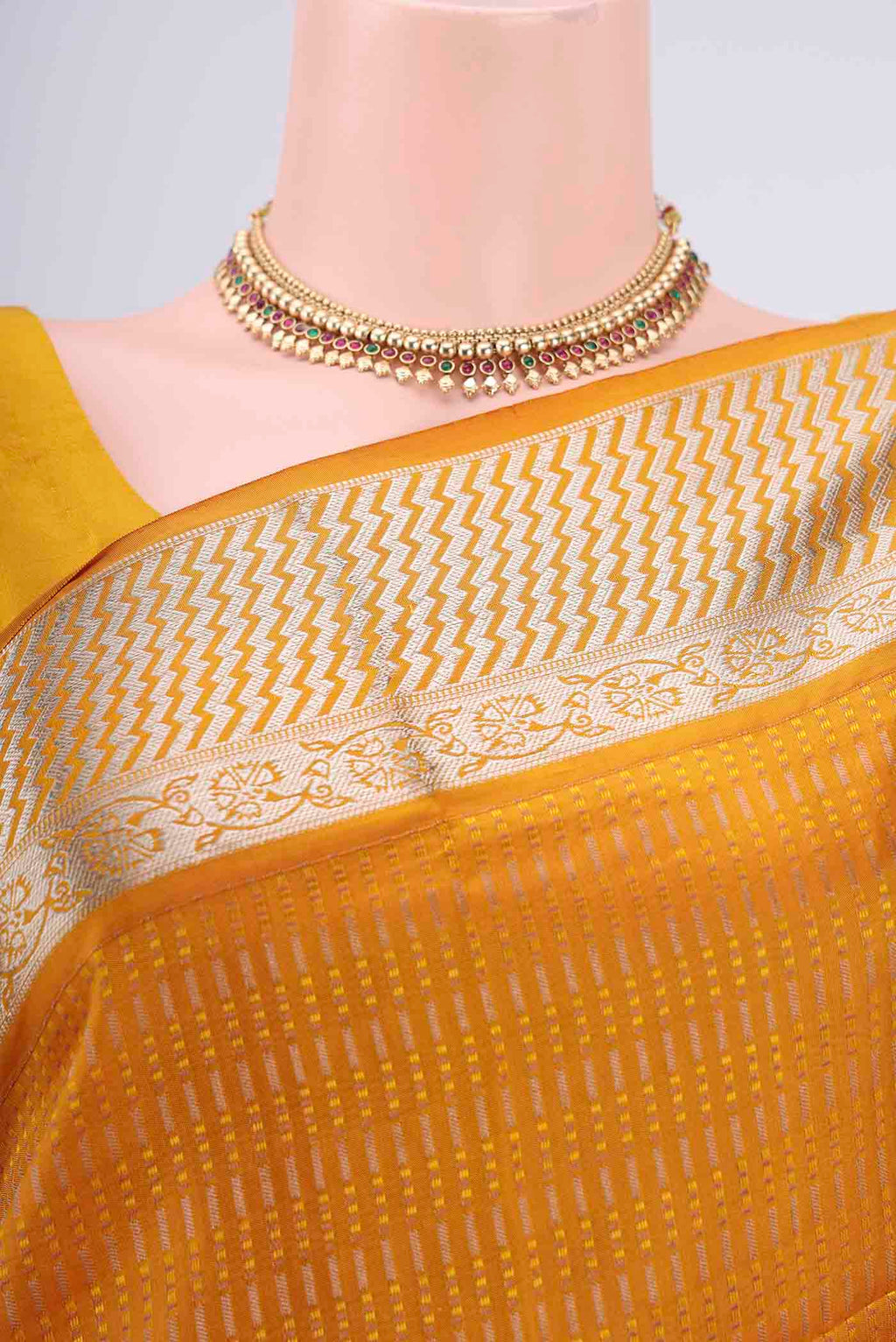 Border image of Mustard Baluchari Silk Saree with Jacquard design on the body and Zari Border. 