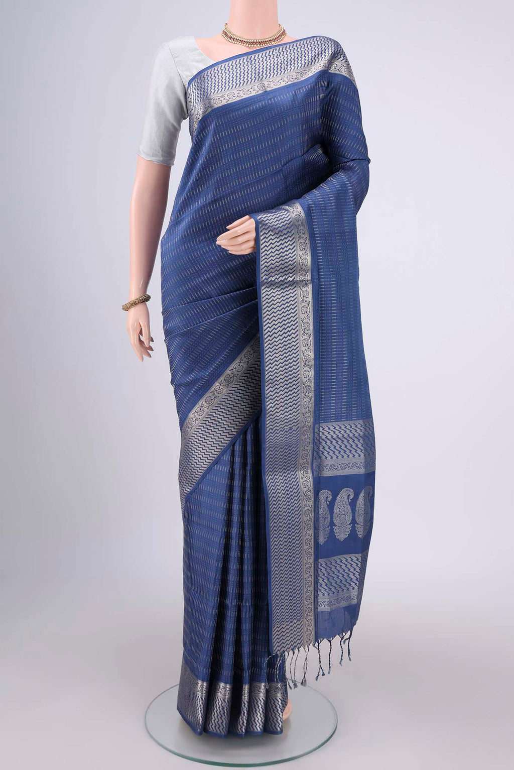 Blue Baluchari Silk Saree with Jacquard design on the body and Zari Border.  displayed on a mannequin