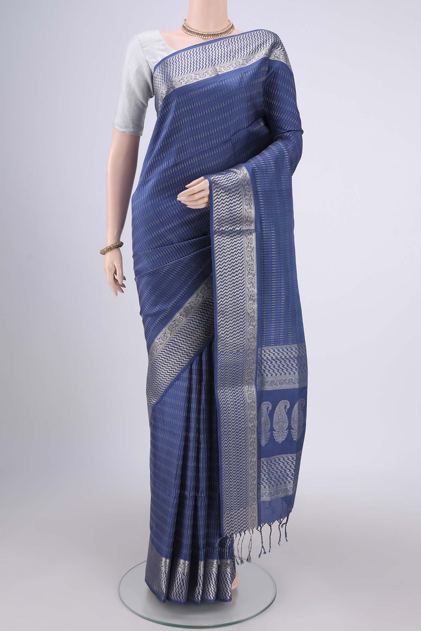 Blue Baluchari Silk Saree with Jacquard design on the body and Zari Border.  displayed on a mannequin