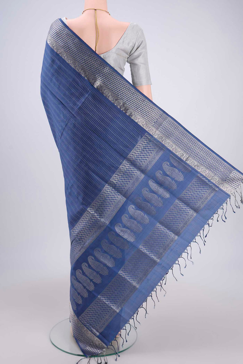 Flat view of Blue Baluchari Silk Saree with Jacquard design on the body and Zari Border. 