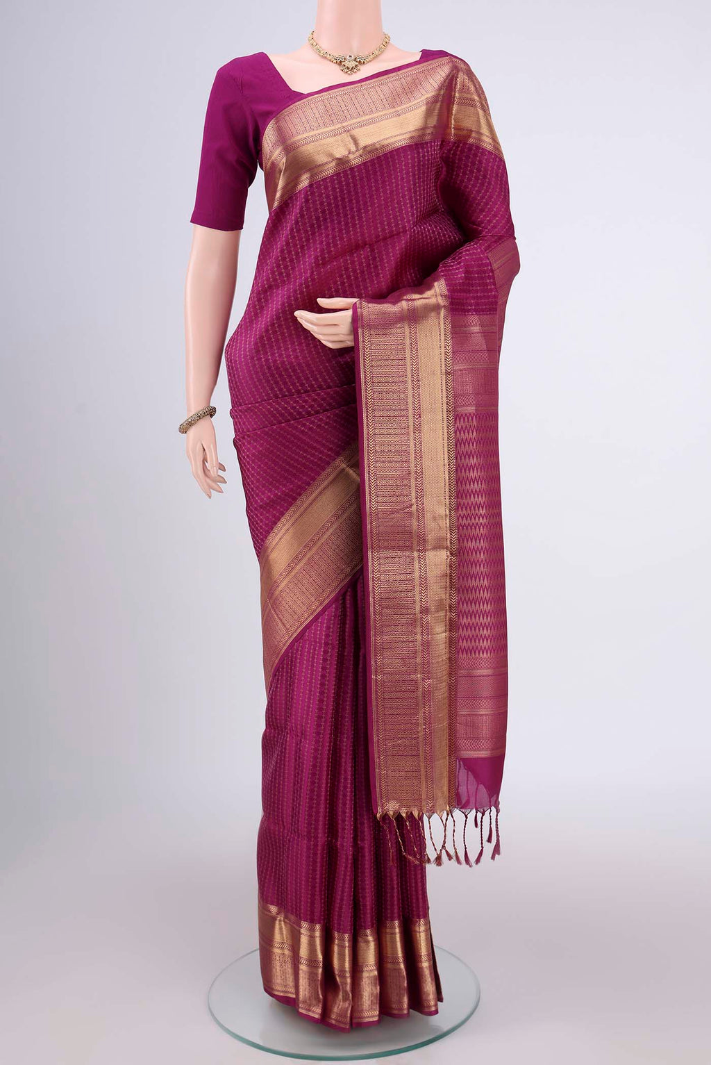 Magenta Baluchari Silk Saree with Jacquard With Zari Butta on the body and Zari Border.  displayed on a mannequin