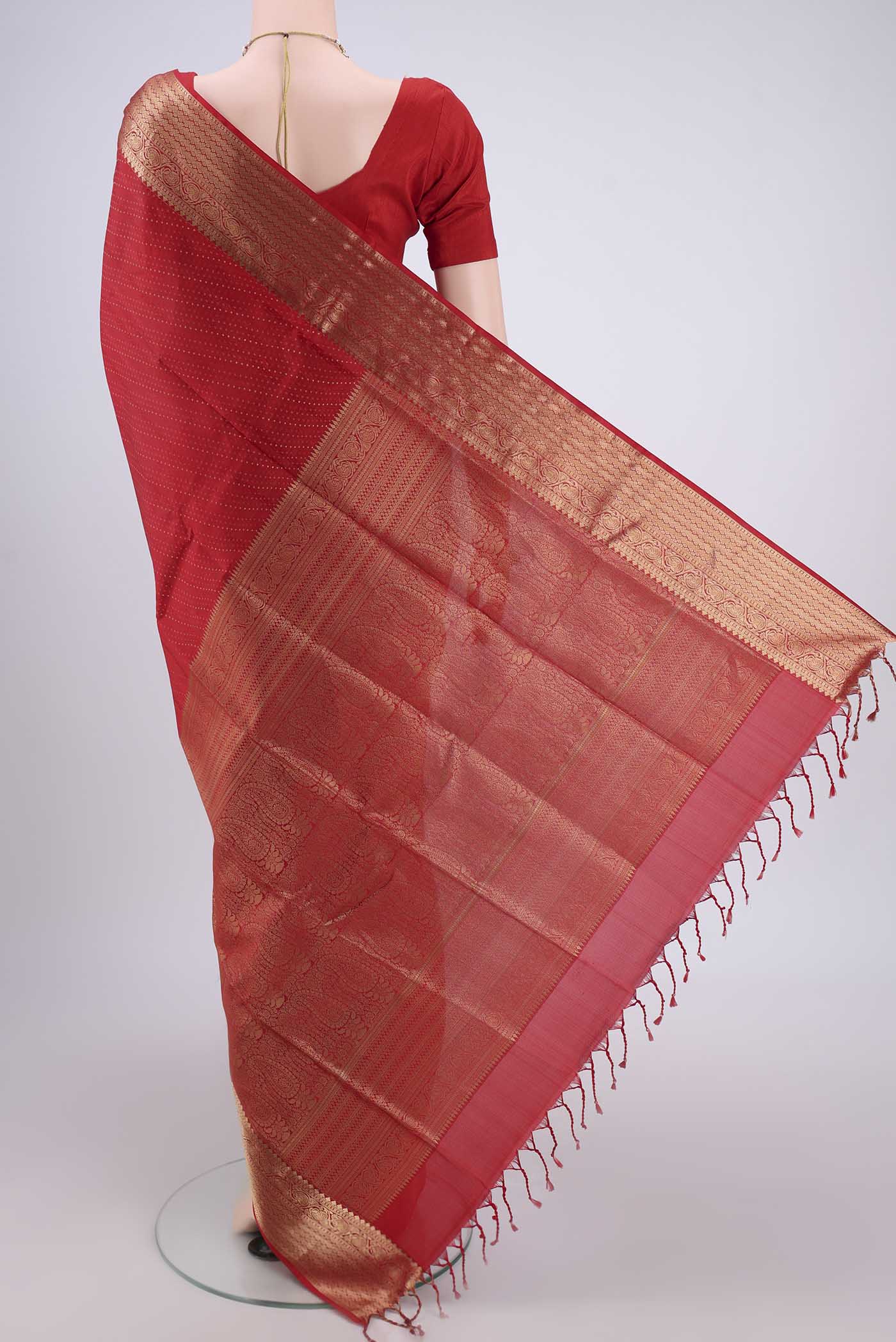 Flat view of Red Baluchari Silk Saree with Jacquard With Zari Butta on the body and Zari Border. 