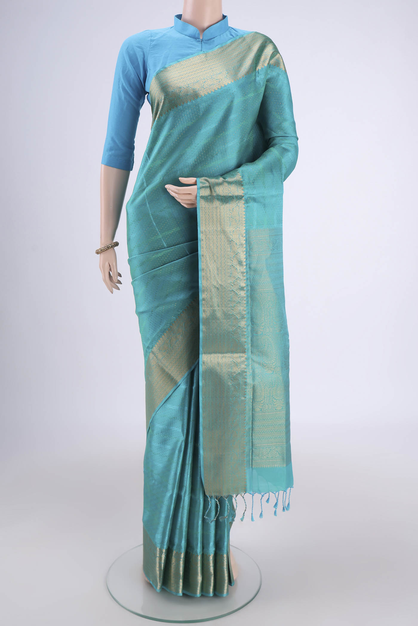 Turquoise Dual Tone Baluchari Silk Saree with Jacquard With Zari Butta on the body and Zari Border.  displayed on a mannequin