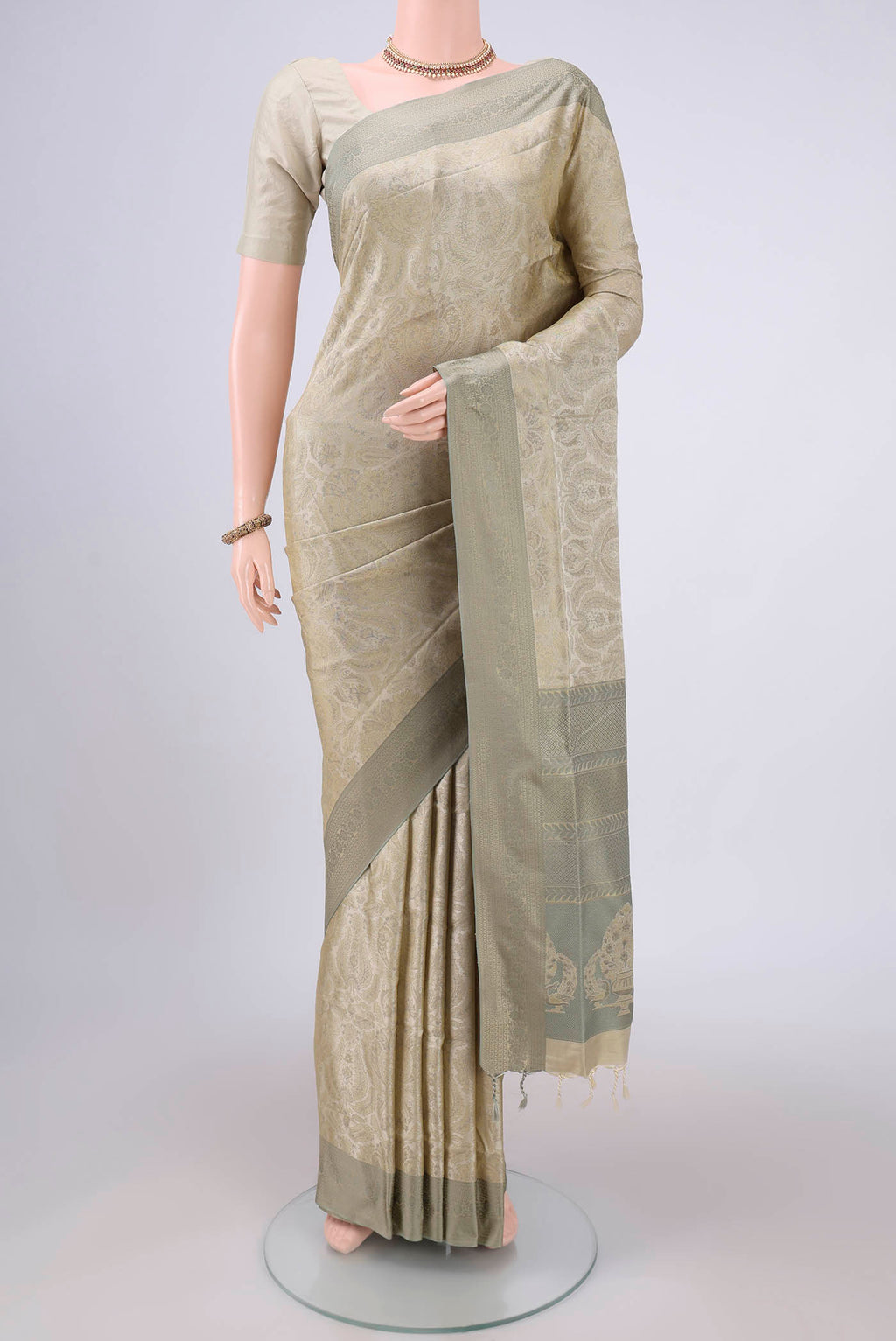 Beige Dual Tone Baluchari Silk Saree with Jacquard design on the body and Zari Border.  displayed on a mannequin