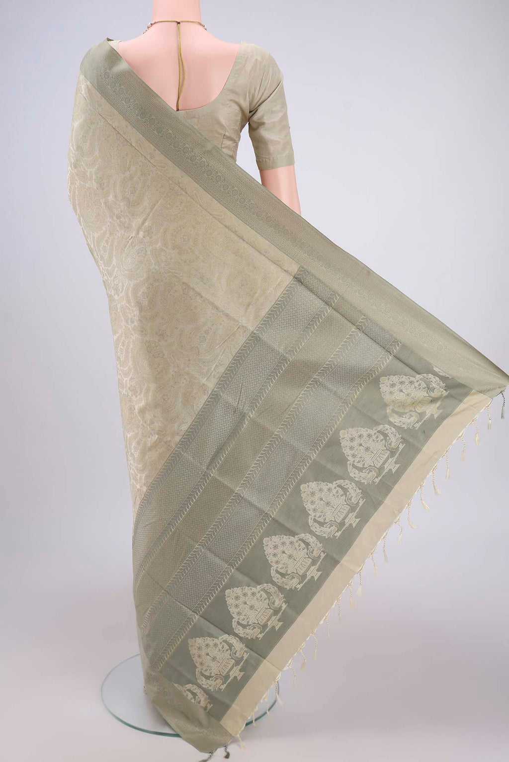 Flat view of Beige Dual Tone Baluchari Silk Saree with Jacquard design on the body and Zari Border. 