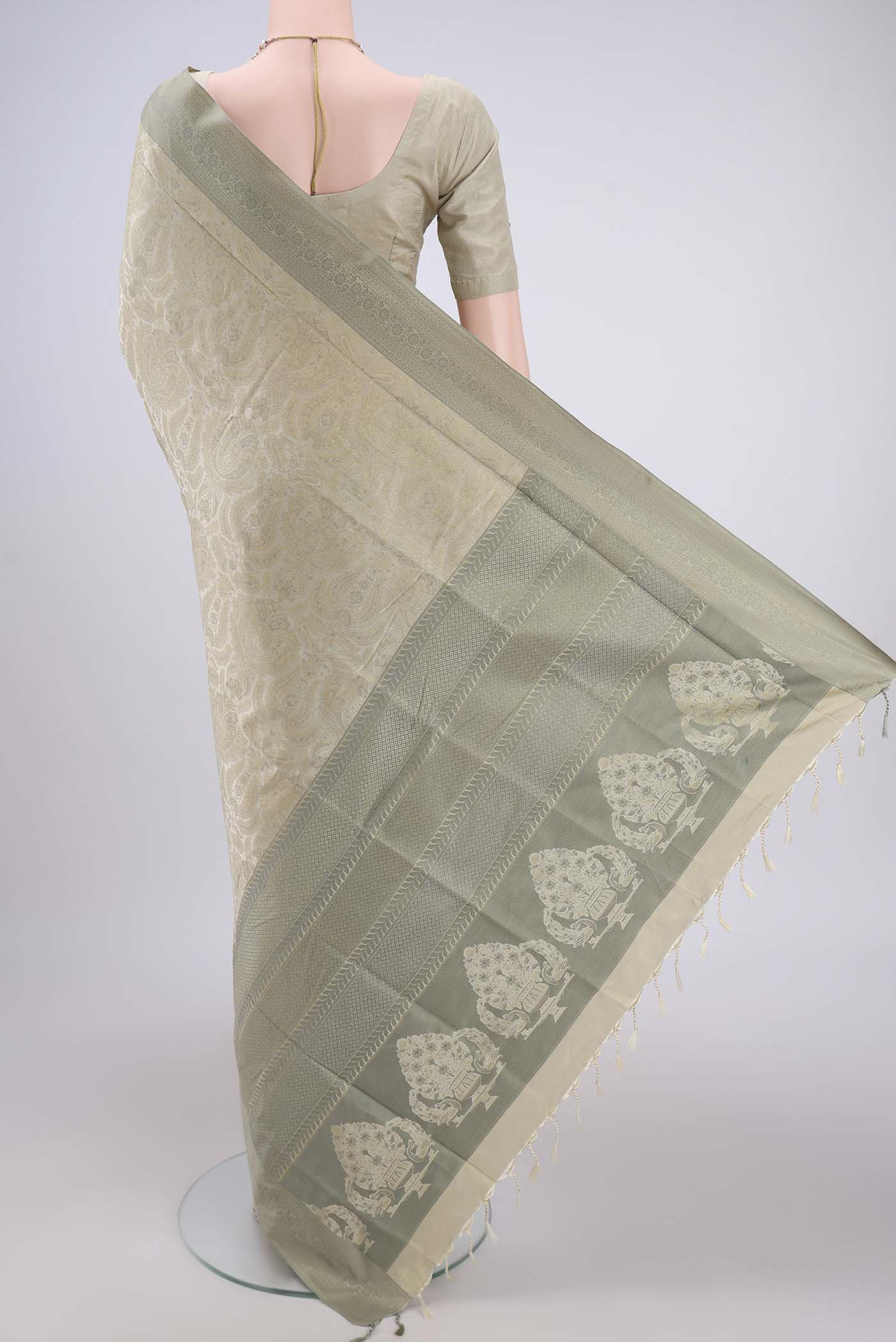 Flat view of Beige Dual Tone Baluchari Silk Saree with Jacquard design on the body and Zari Border. 