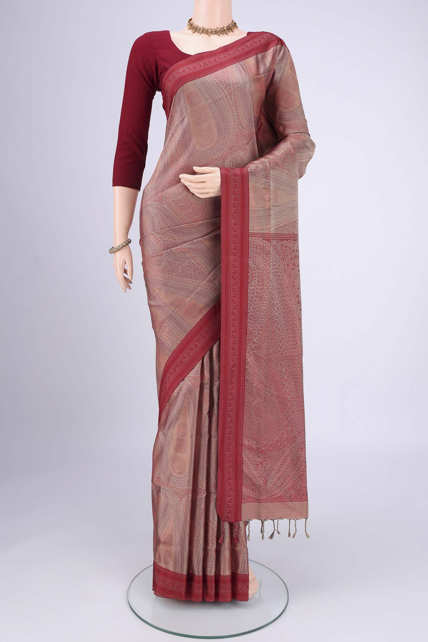 Coral Soft Silk Saree with Jacquard design on the body and Thread Border.  displayed on a mannequin