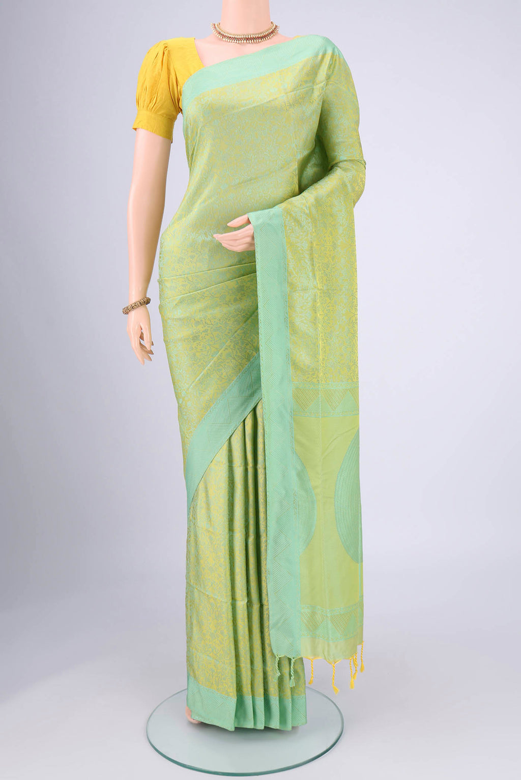Acid Green Soft Silk Saree with Jacquard design on the body and Thread Border.  displayed on a mannequin