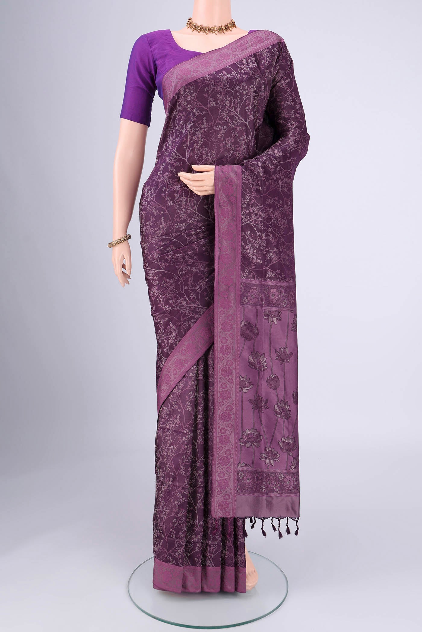 Purple Soft Silk Saree with Jacquard design on the body and Thread Border.  displayed on a mannequin