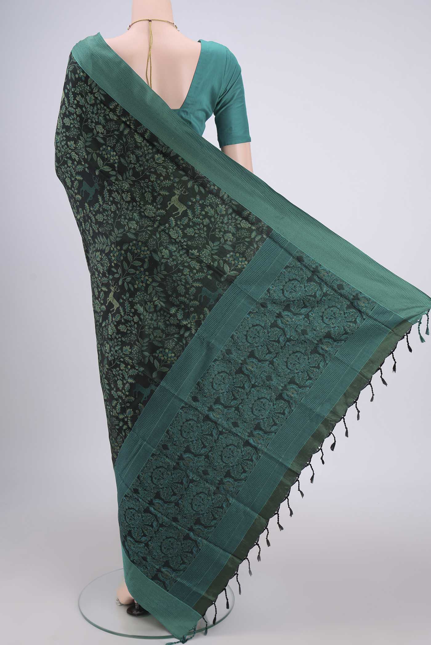 Flat view of Olive Green Dual Tone Baluchari Silk Saree with Jacquard design on the body and Zari Border. 