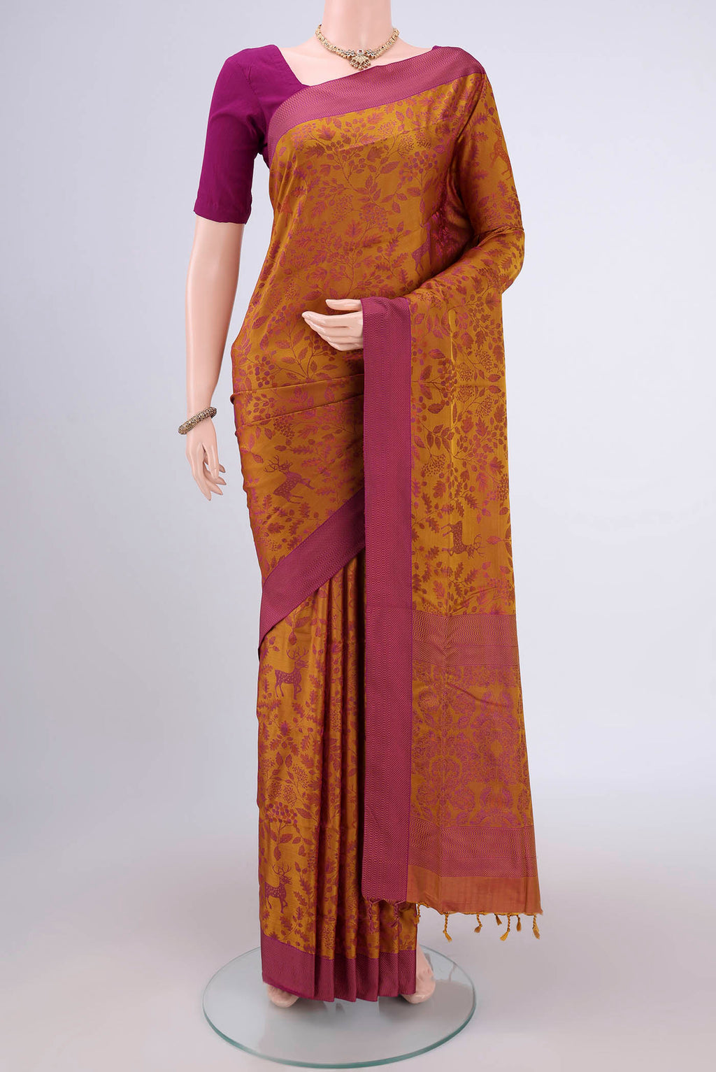 Mustard Dual Tone Baluchari Silk Saree with Jacquard design on the body and Zari Border.  displayed on a mannequin