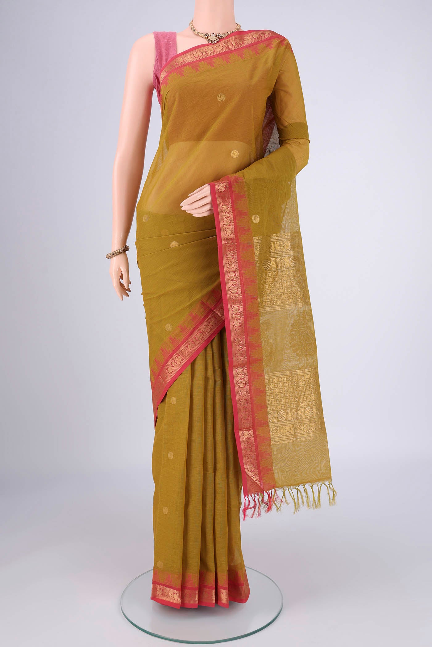 Mehandi Green Kanchi Cotton Saree with Polka Dots on the body and Temple Border.  displayed on a mannequin
